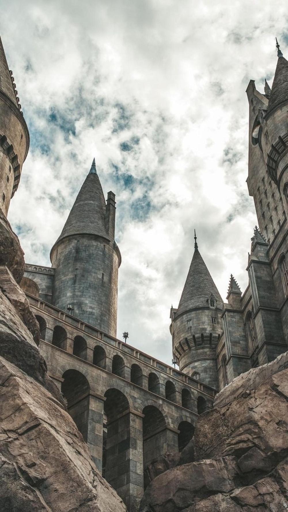 1000x1777 white clouds hovering above grey castle photo