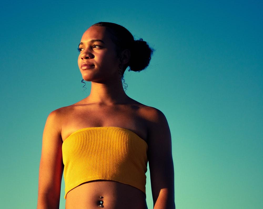 1000x794 woman wearing crop top holding her head photo