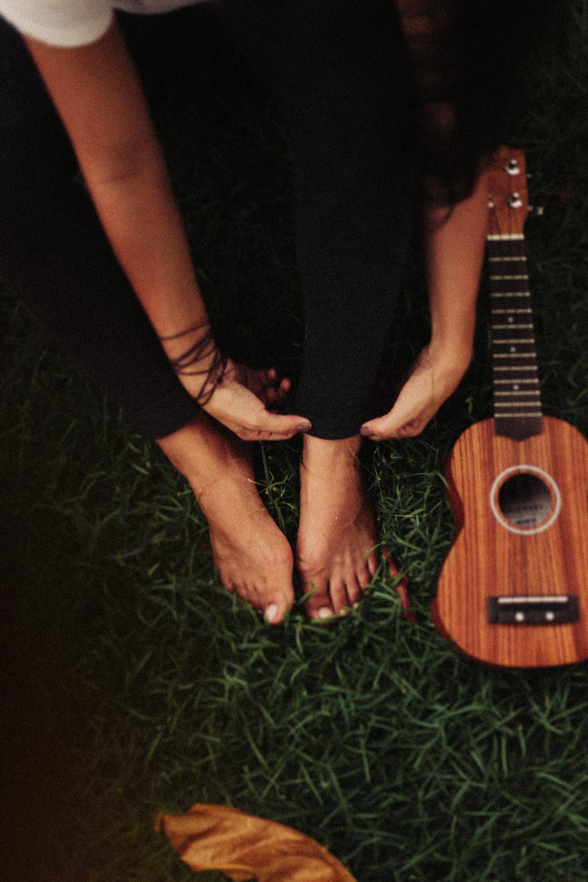 1200x1800 Person Sitting on Green Grass Field Beside Ukulele · Free