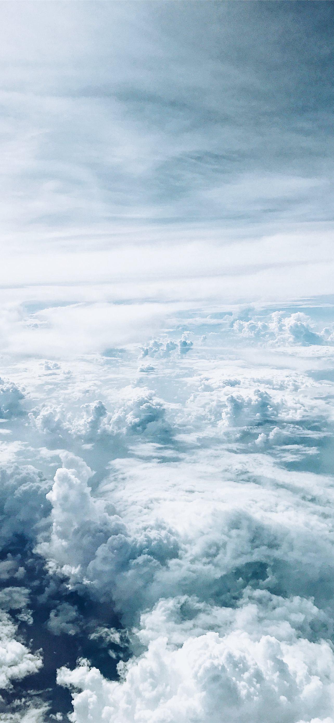 1284x2778 sea of clouds during daytime iPhone 12 Wallpaper Free Download