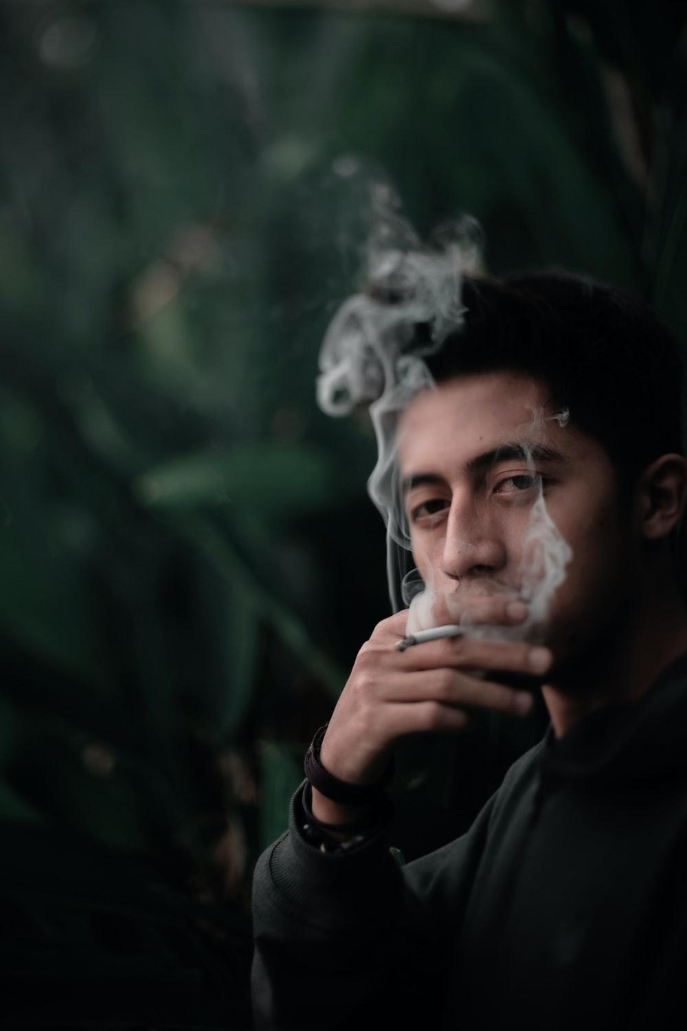1000x1500 man smoking near garden photo
