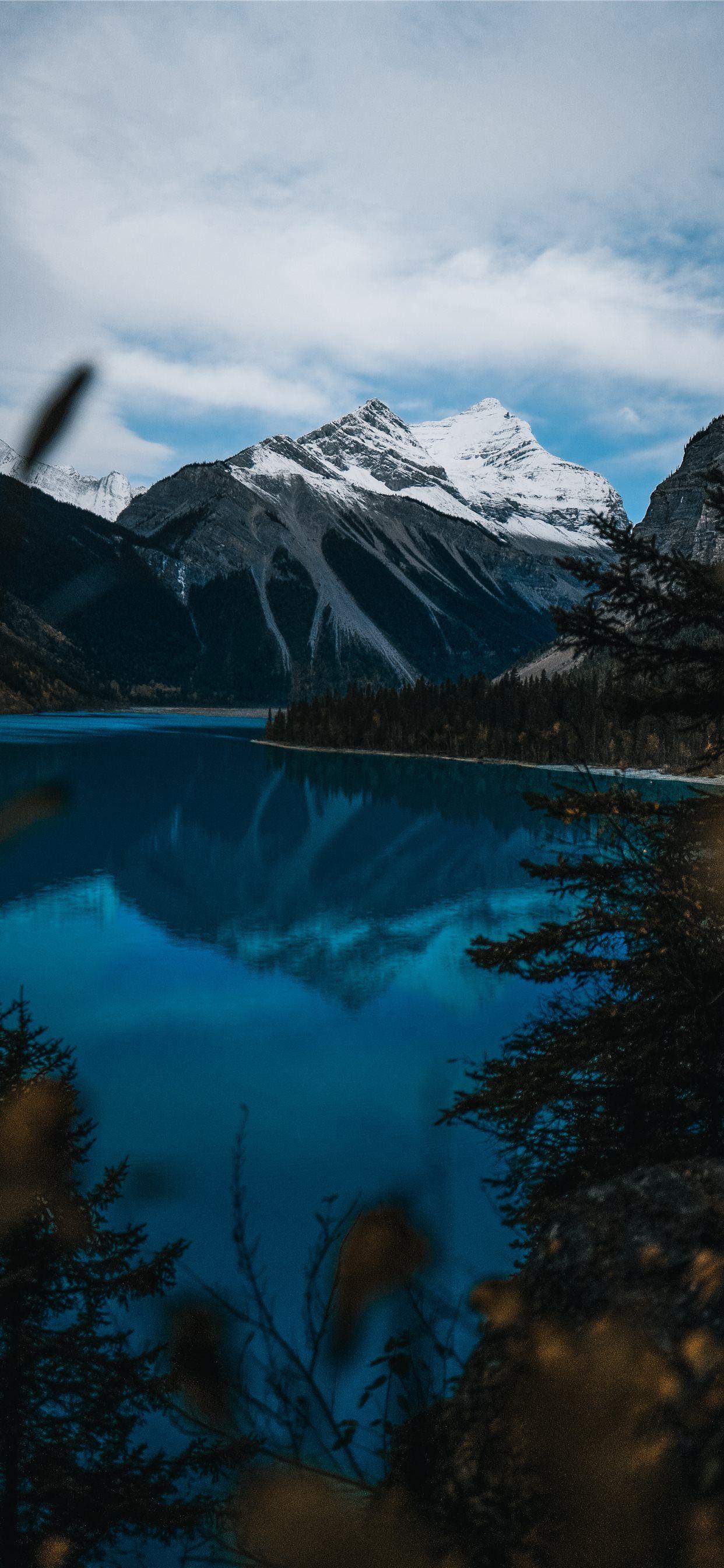 1242x2688 body of water near snow covered mountain during da. iPhone 11 Wallpaper Free Download