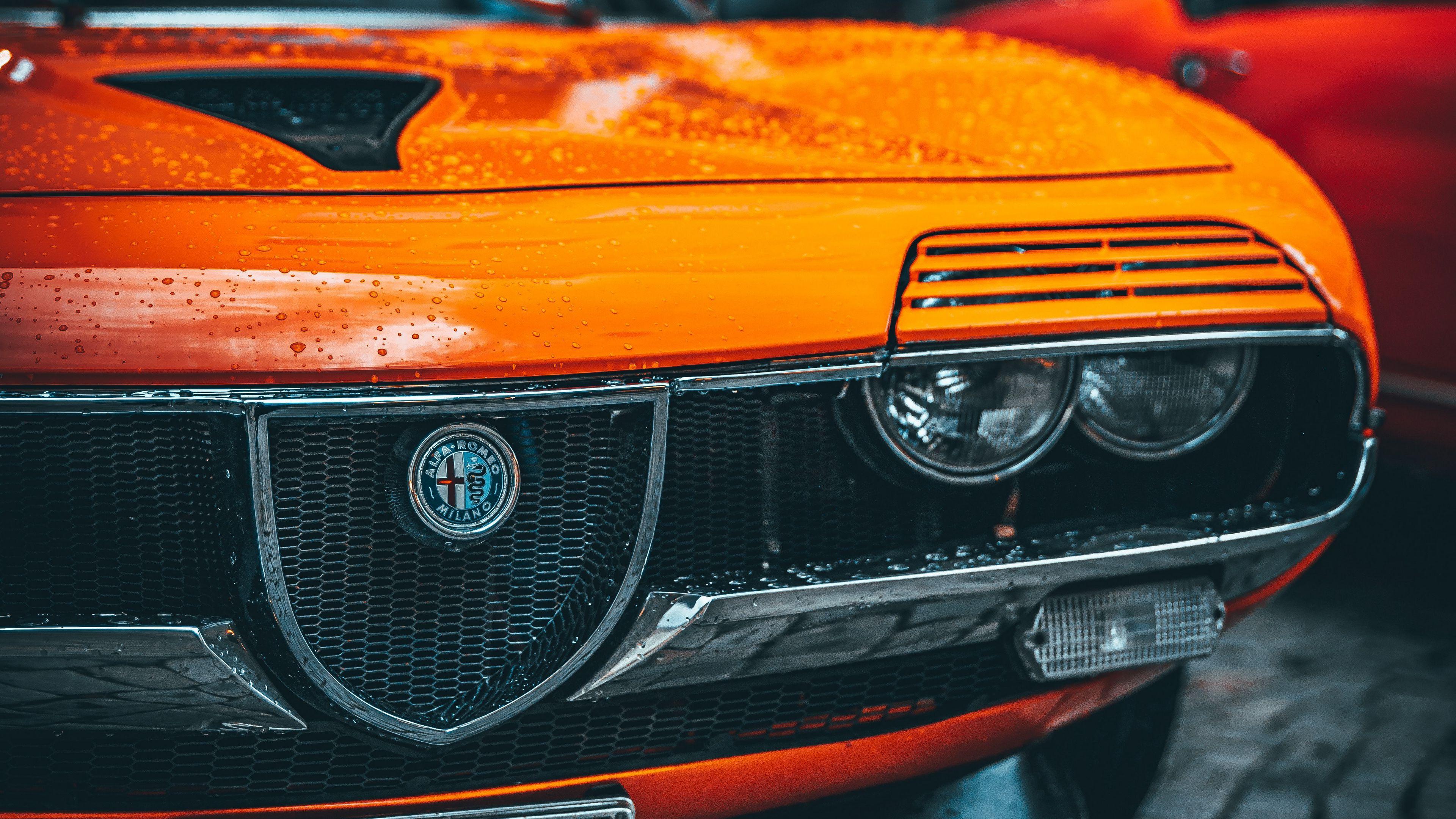 3840x2160 Download wallpaper 3840x2160 alfa romeo, car, orange, wet, front view 4k uhd 16:9 HD background
