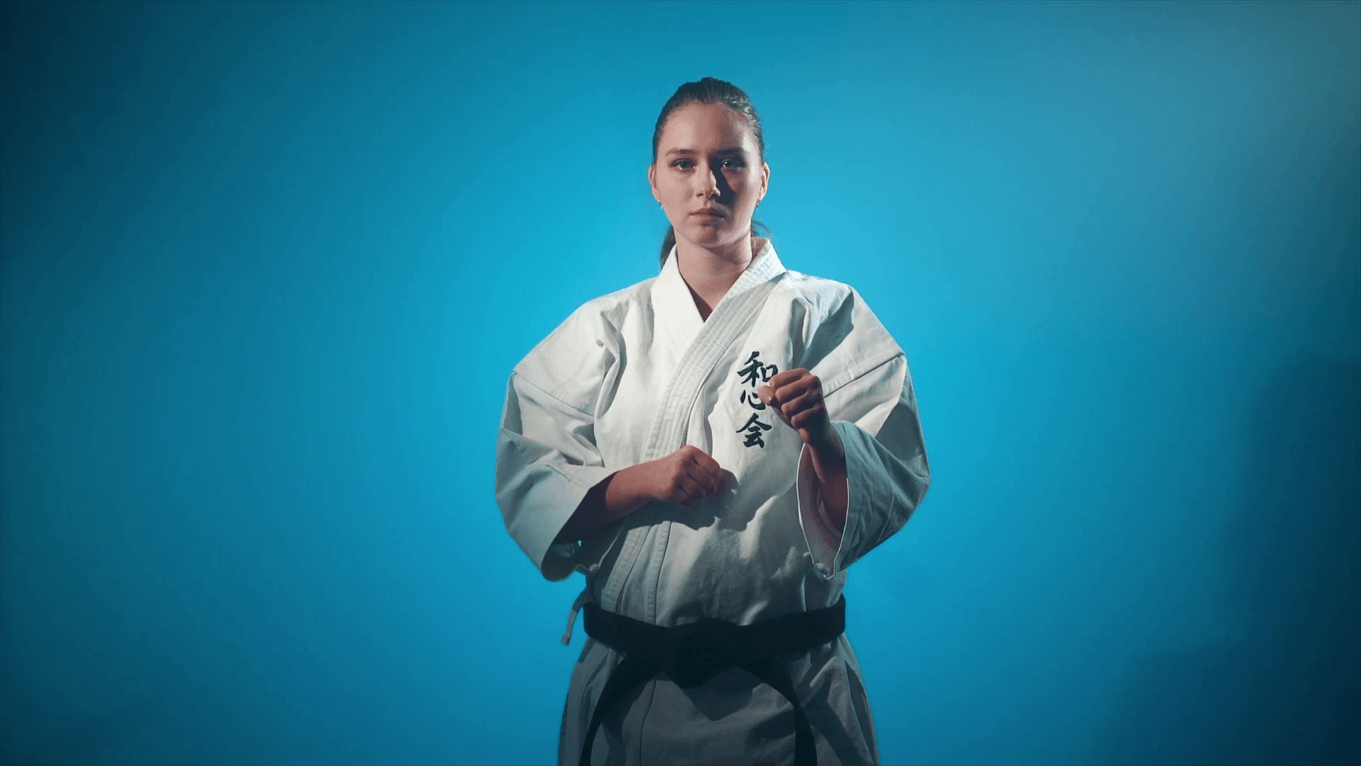 1920x1080 A woman making karate punches isolated on blue Stock Video Footage
