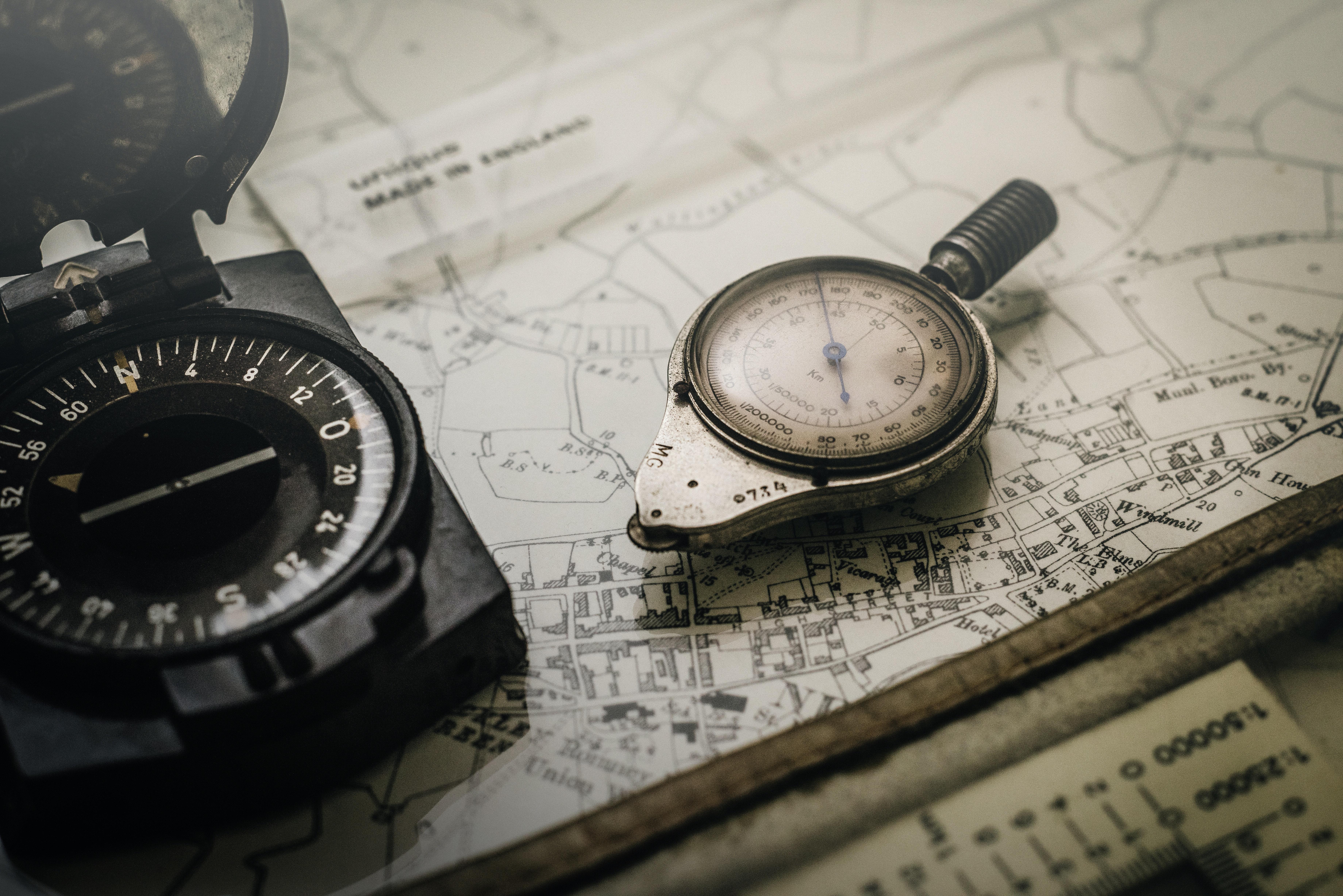 7360x4912 Shallow Focus Photography of Black and Silver Compasses on Top of Map · Free