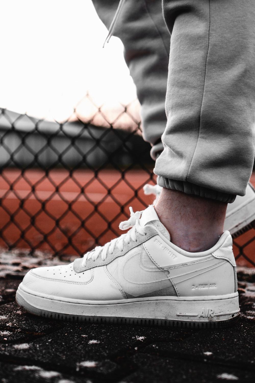 1000x1500 person in gray pants wearing white nike air force 1 low photo