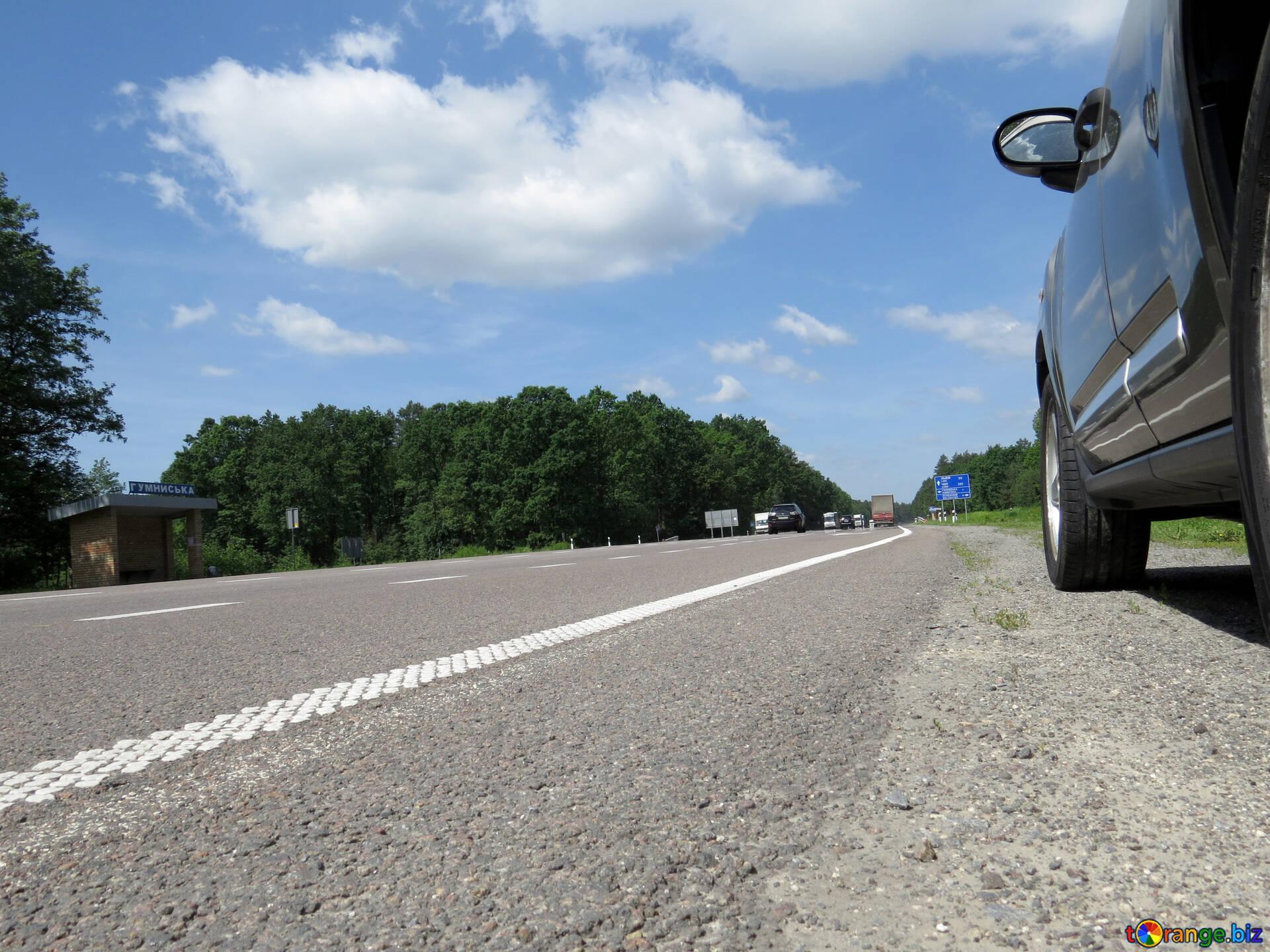 1920x1440 Road markings image low angle view of asphalt road, the side of a car on the right, trees at the horizon, blue sky with large cloud image signs № 52028. torange.biz