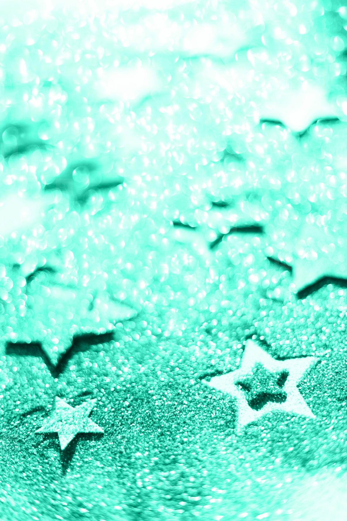 1184x1774 Christmas celebration. Abstract background for new year party. Patter of gold stars with lights, bokeh. Trendy green and turquoise color. Glitter stars in mint color