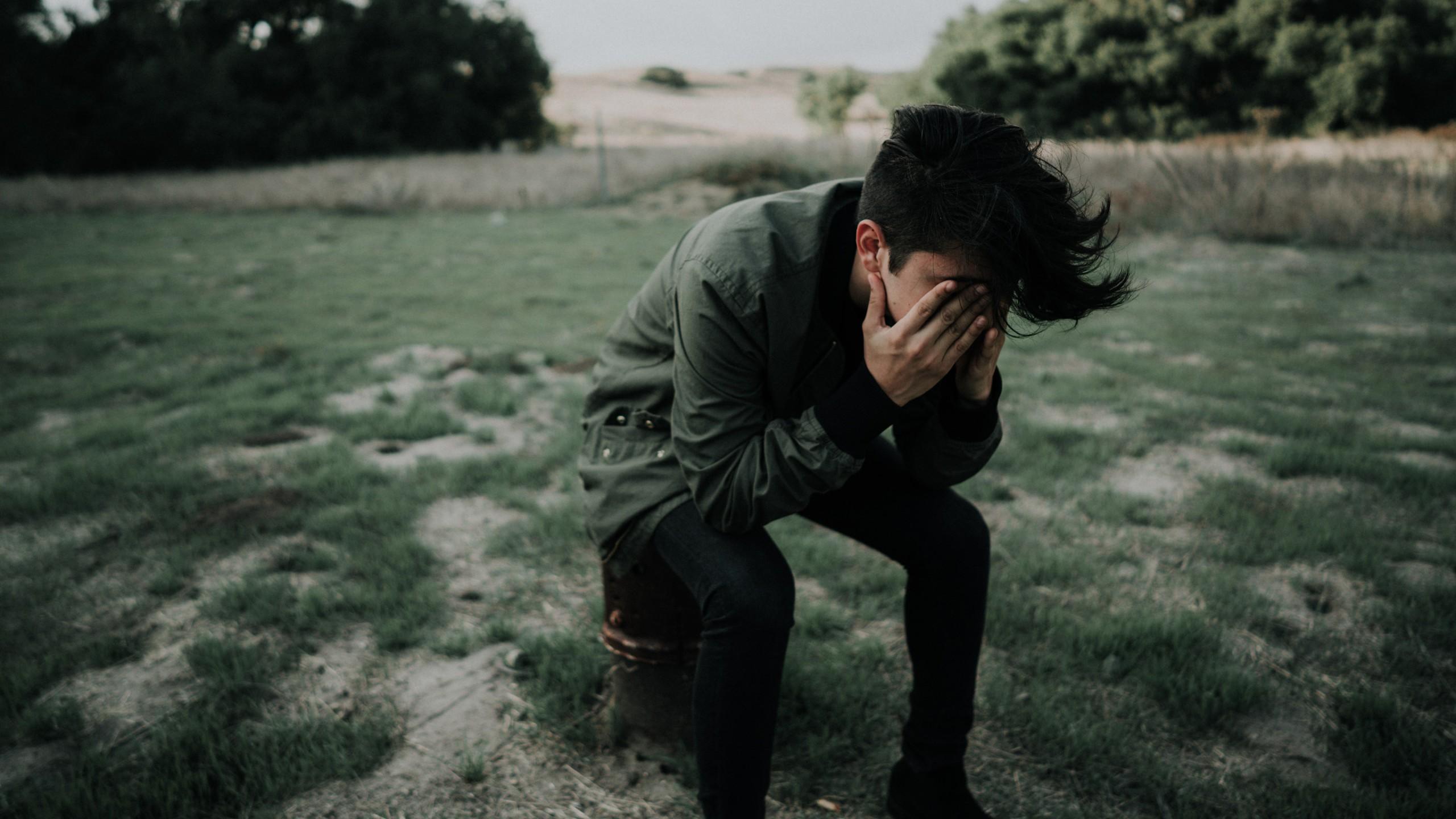 2560x1440 Sad Boy Sitting Alone Crying 4K HD Wallpaper