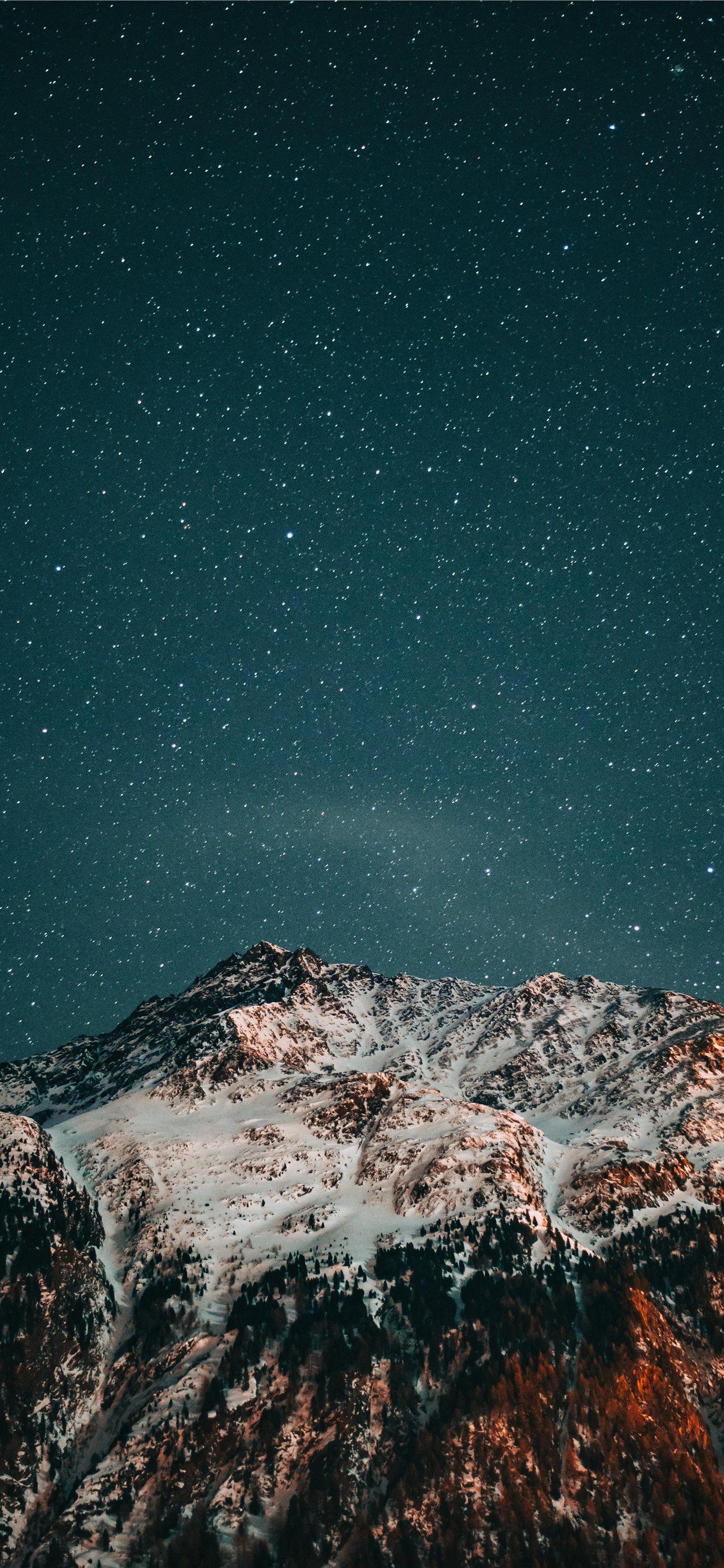 1242x2688 snow covered mountain under starry night iPhone X Wallpaper Free Download