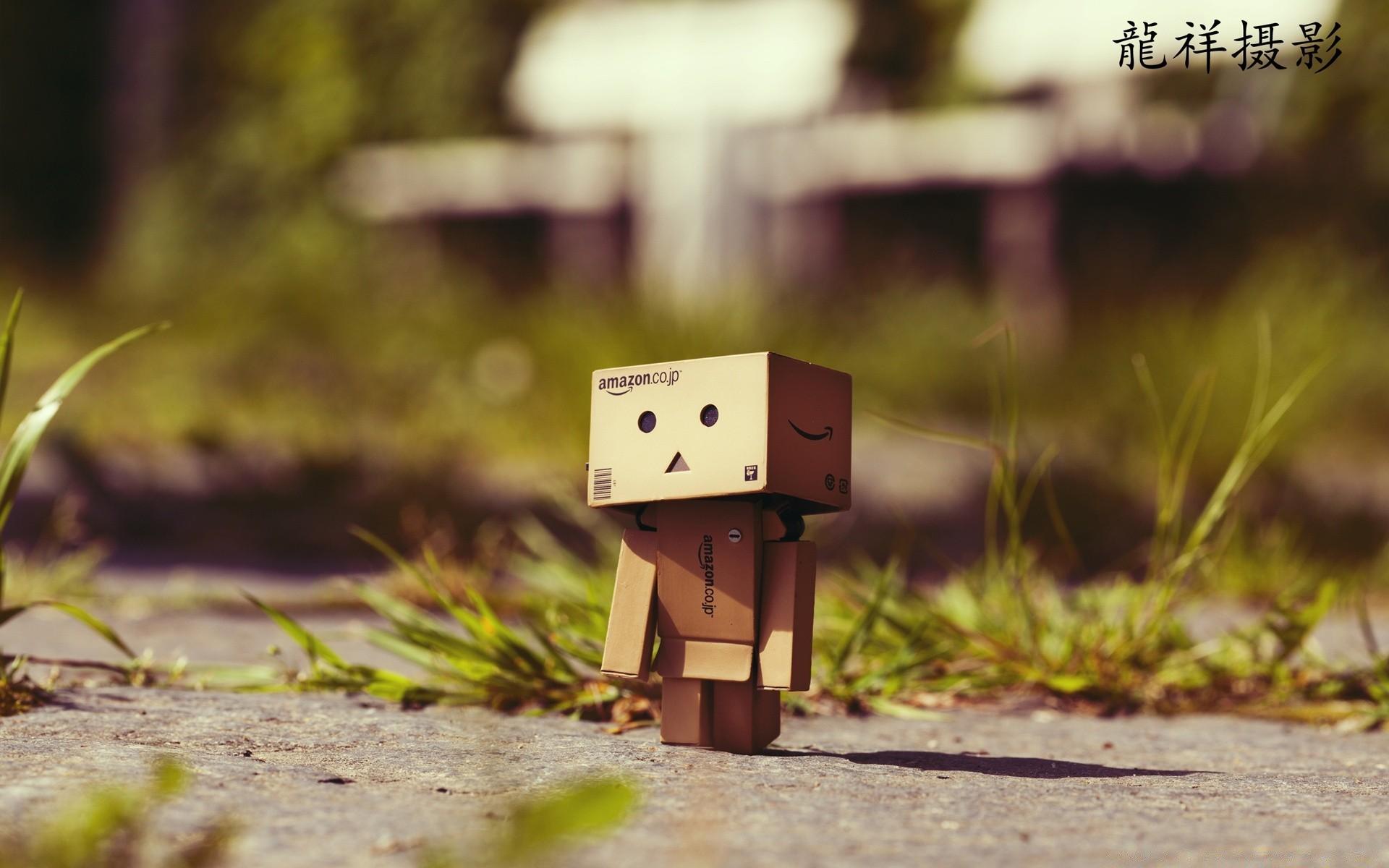 1920x1200 A small robot made of paper on asphalt phone background image