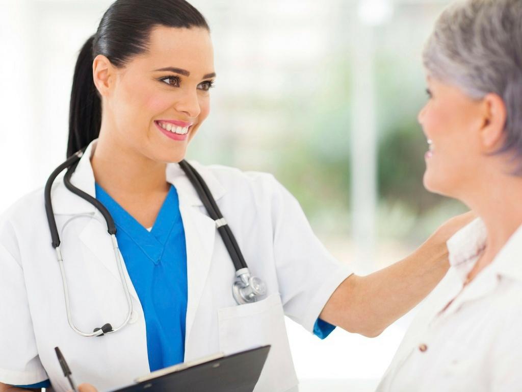 1024x768 female doctor smiling with patient the Cusp