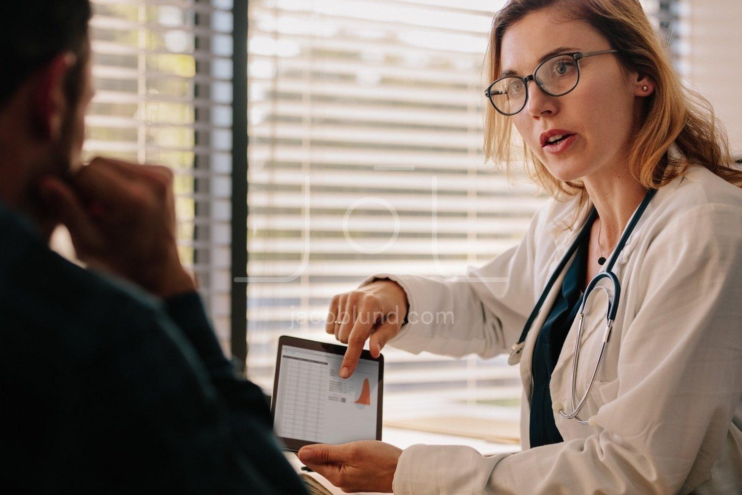 1500x1000 Doctor talking with patient with test results on tablet