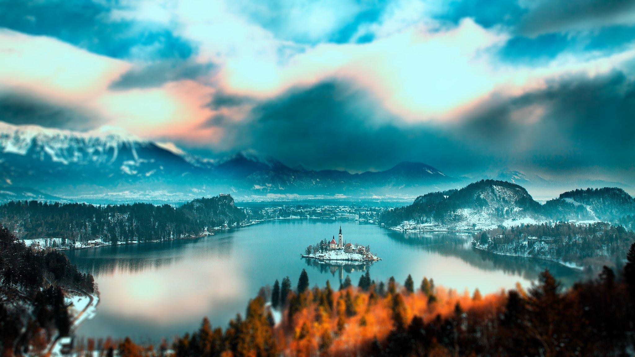 2048x1152 Slovenia Bled lake Slovenia Lake Bled mountain forest trees island church home lake water snow winter sky clouds landscape nature wallpaperx1152