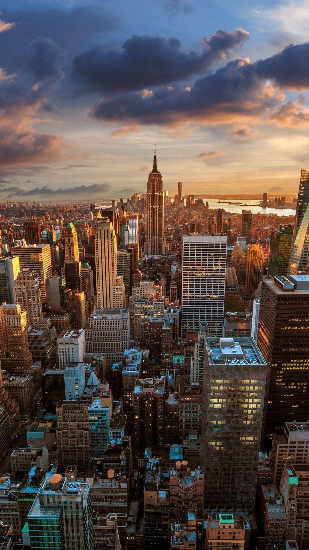 city-with-high-rising-buildings-under-yellow-sky-during-sunset-hd-new