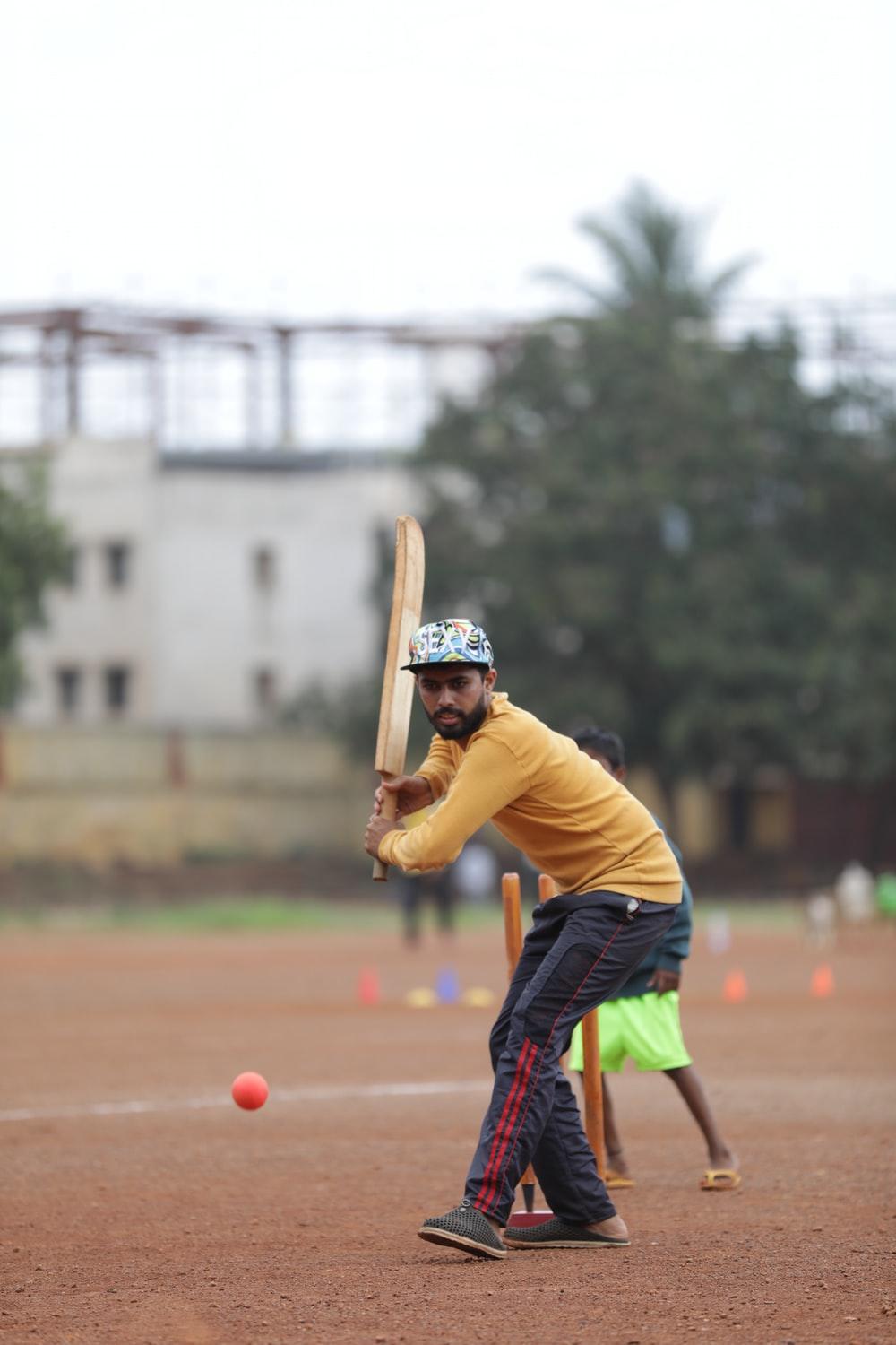 1000x1500 man holding cricket bat on field photo