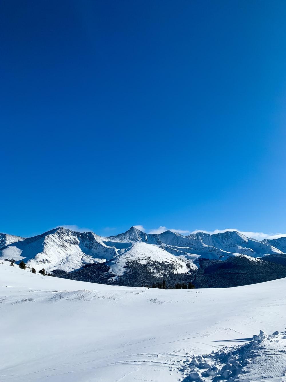 1000x1333 snow covered mountain under blue sky during daytime photo