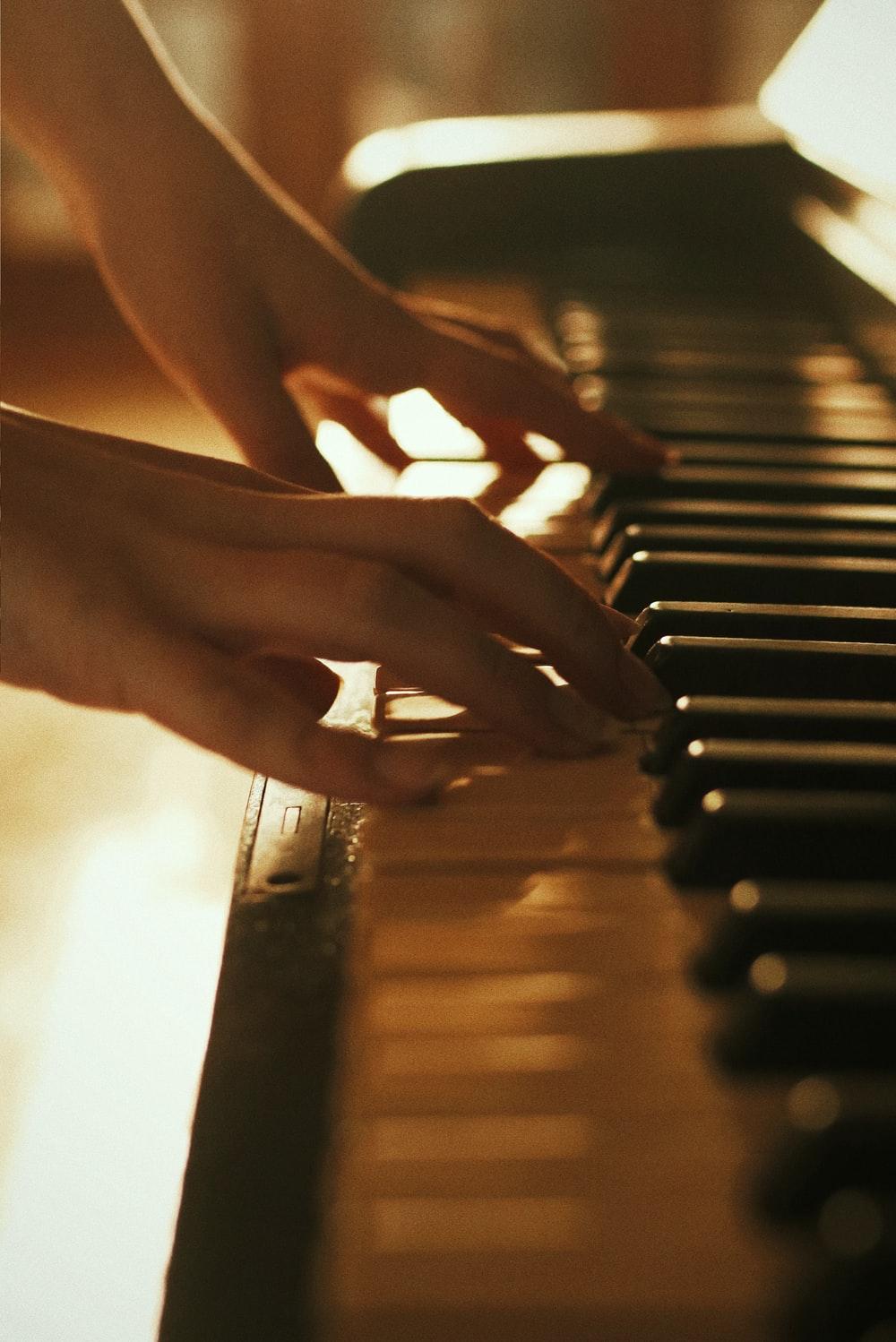 1000x1498 person playing piano during daytime photo