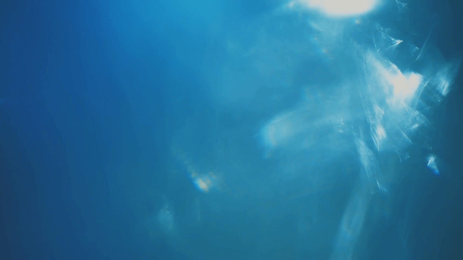 1920x1080 Subtle light leak on dark background, moving lens flare. Blue pastel