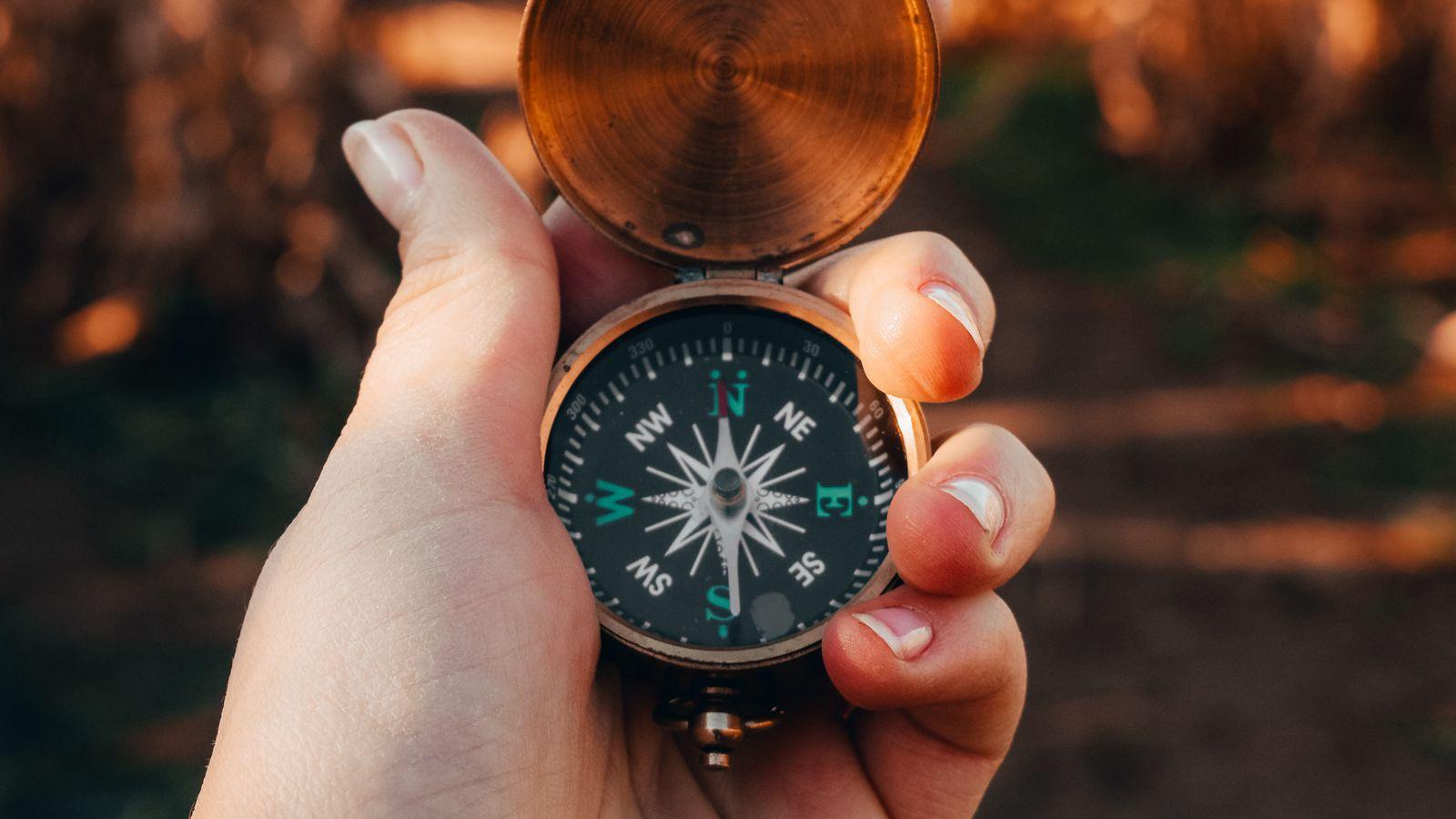1600x900 Download wallpaper 1600x900 compass, hand, device, metal widescreen 16:9 HD background