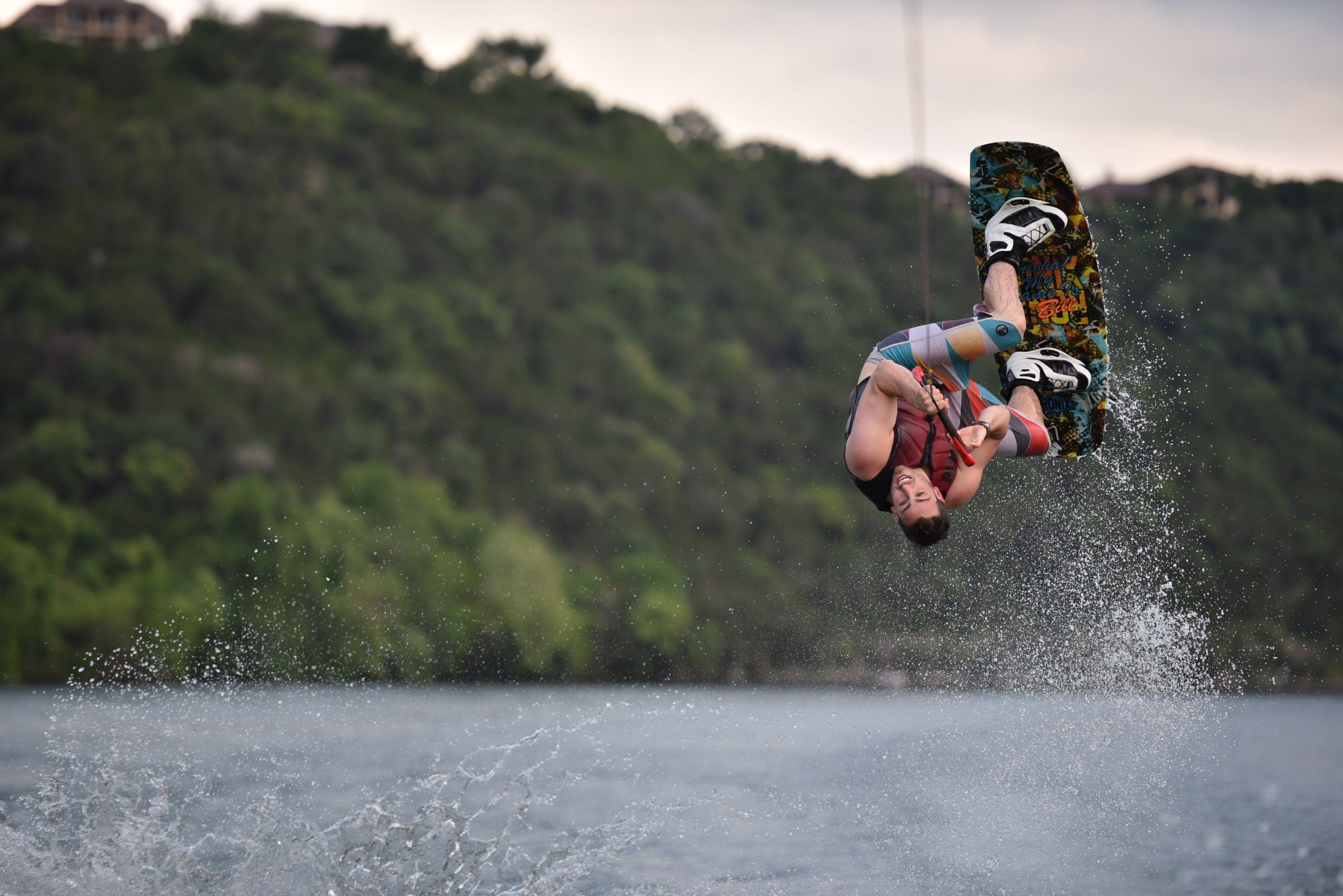 3840x2563 wakeboarding athlete flipping up to the sky in lake austinmale