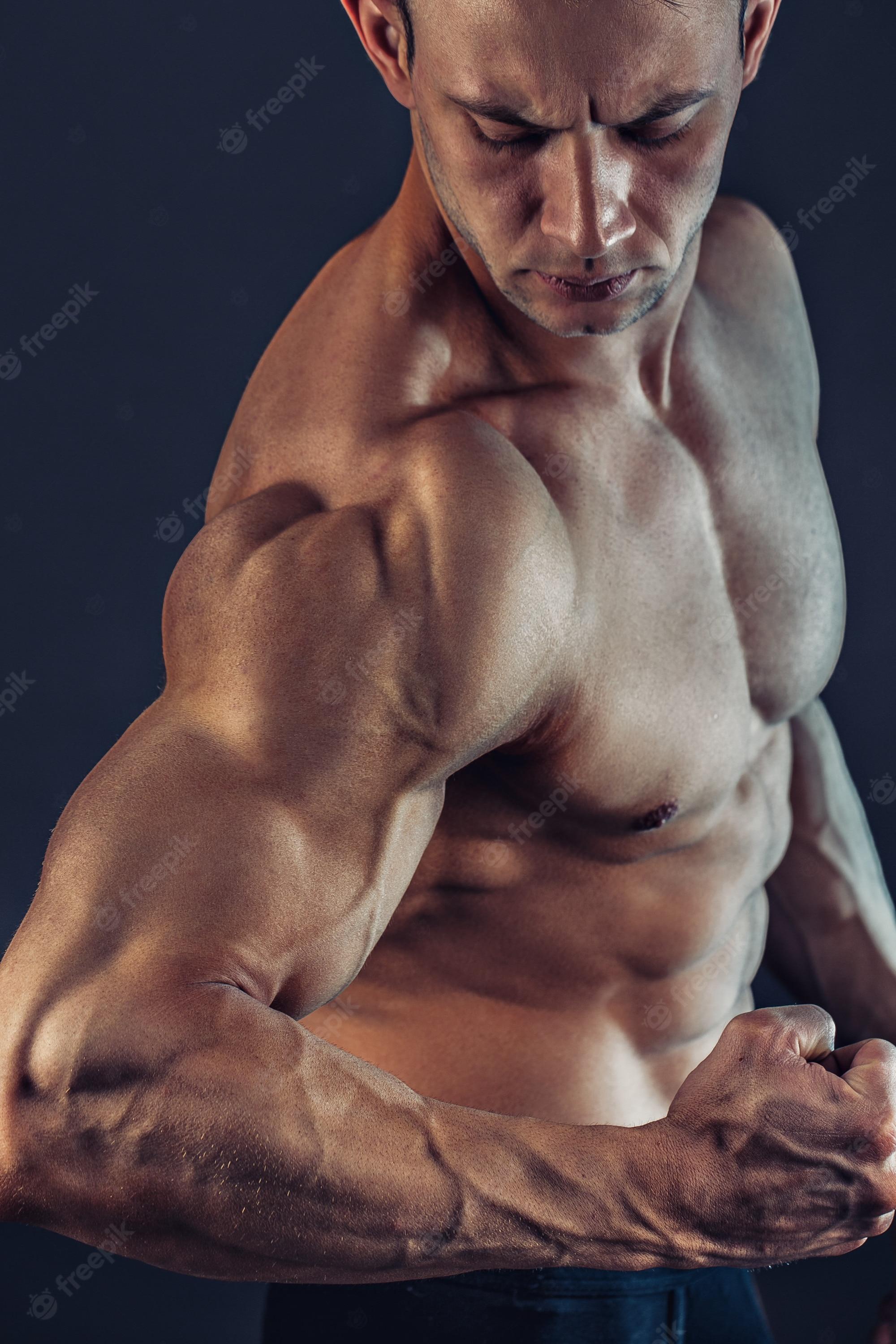 2000x3000 Premium Photo. Shirtless male bodybuilder with muscular build strong abs showing. shot of healthy muscular young man. perfect fit, six pack, abs, abdominal muscle, shoulders, deltoids, biceps, triceps and chest