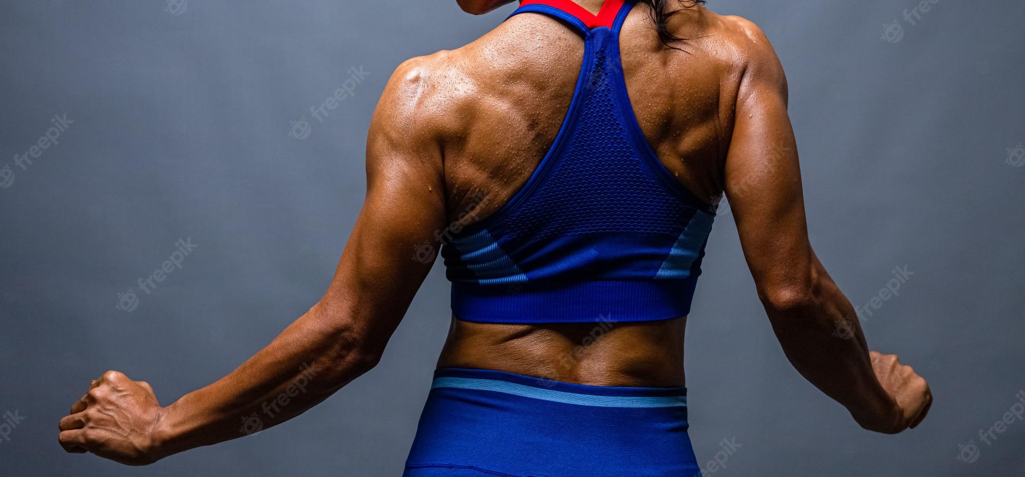 2000x931 Premium Photo. Strong bald bodybuilder with six pack. bodybuilder woman with perfect abs, shoulders, biceps, triceps and chest, personal fitness trainer flexing his muscles