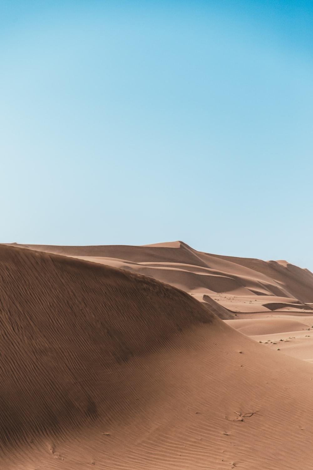 1000x1500 brown sand under white cloudy sky photo