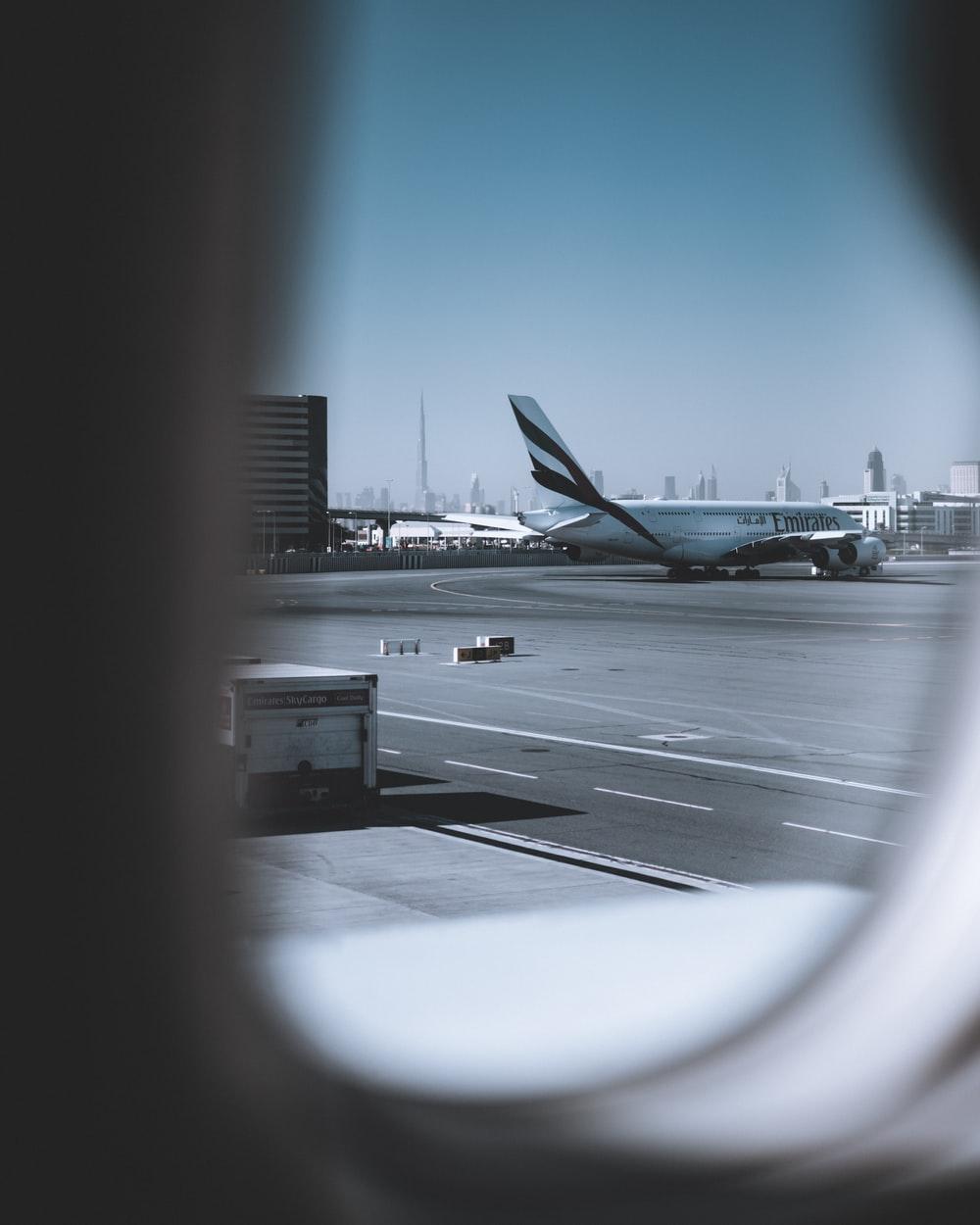 1000x1250 white airplane on airport during daytime photo