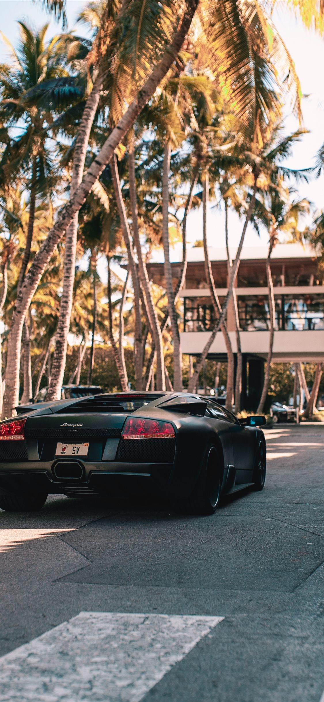 1125x2436 black sports coupe on road during daytime iPhone X Wallpaper Free Download