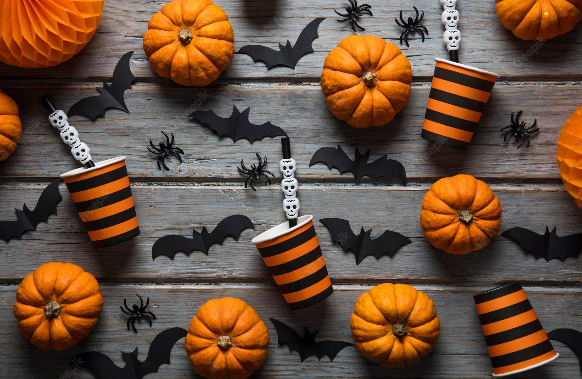 2000x1303 Premium Photo. Halloween party decorations on a rustic wooden background