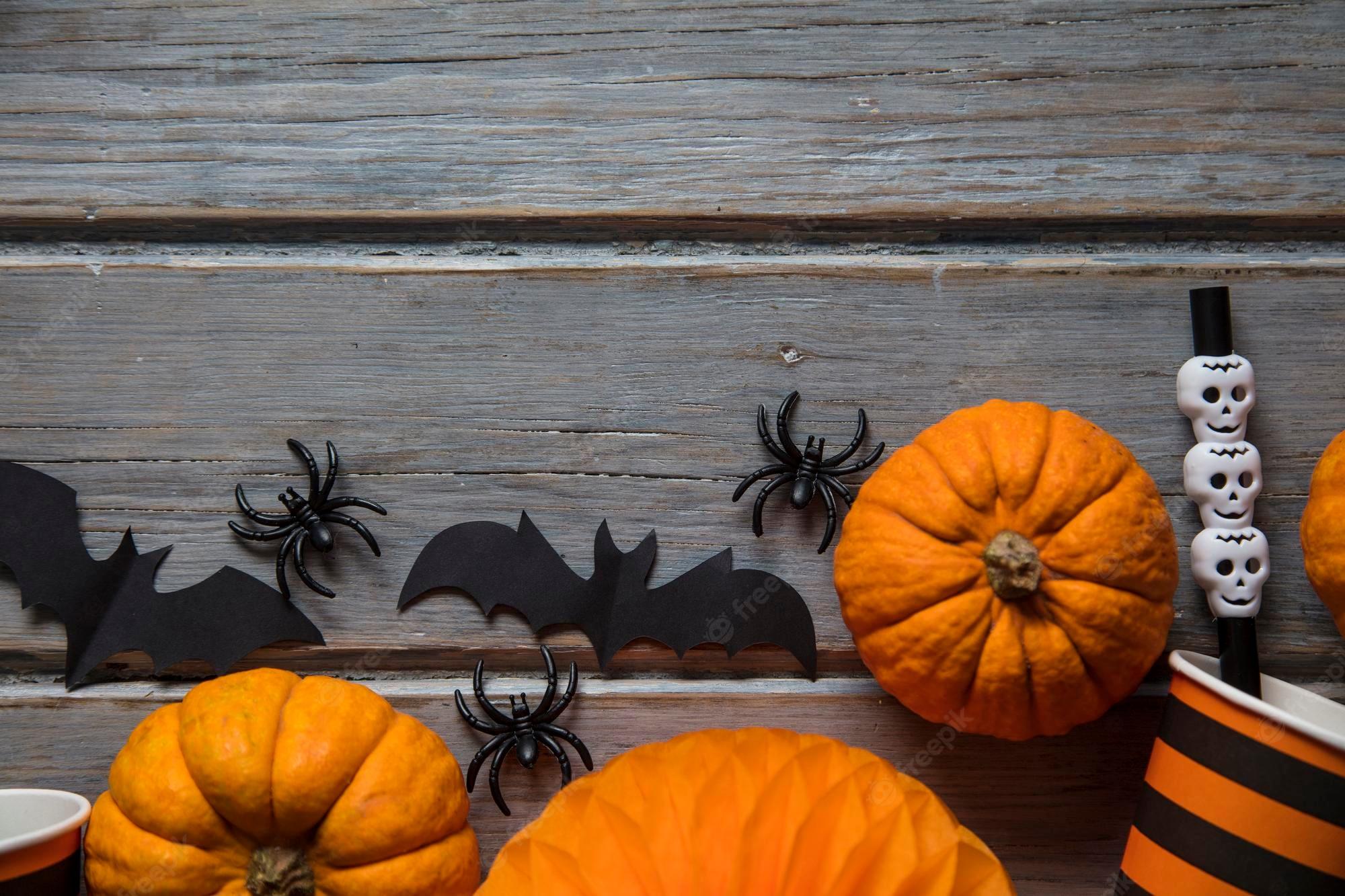 2000x1333 Premium Photo. Halloween party decorations on a rustic wooden background