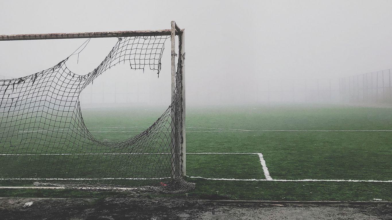 1366x768 Download wallpaper 1366x768 football gate, torn, fog, lawn, mood, gloomy tablet, laptop HD background