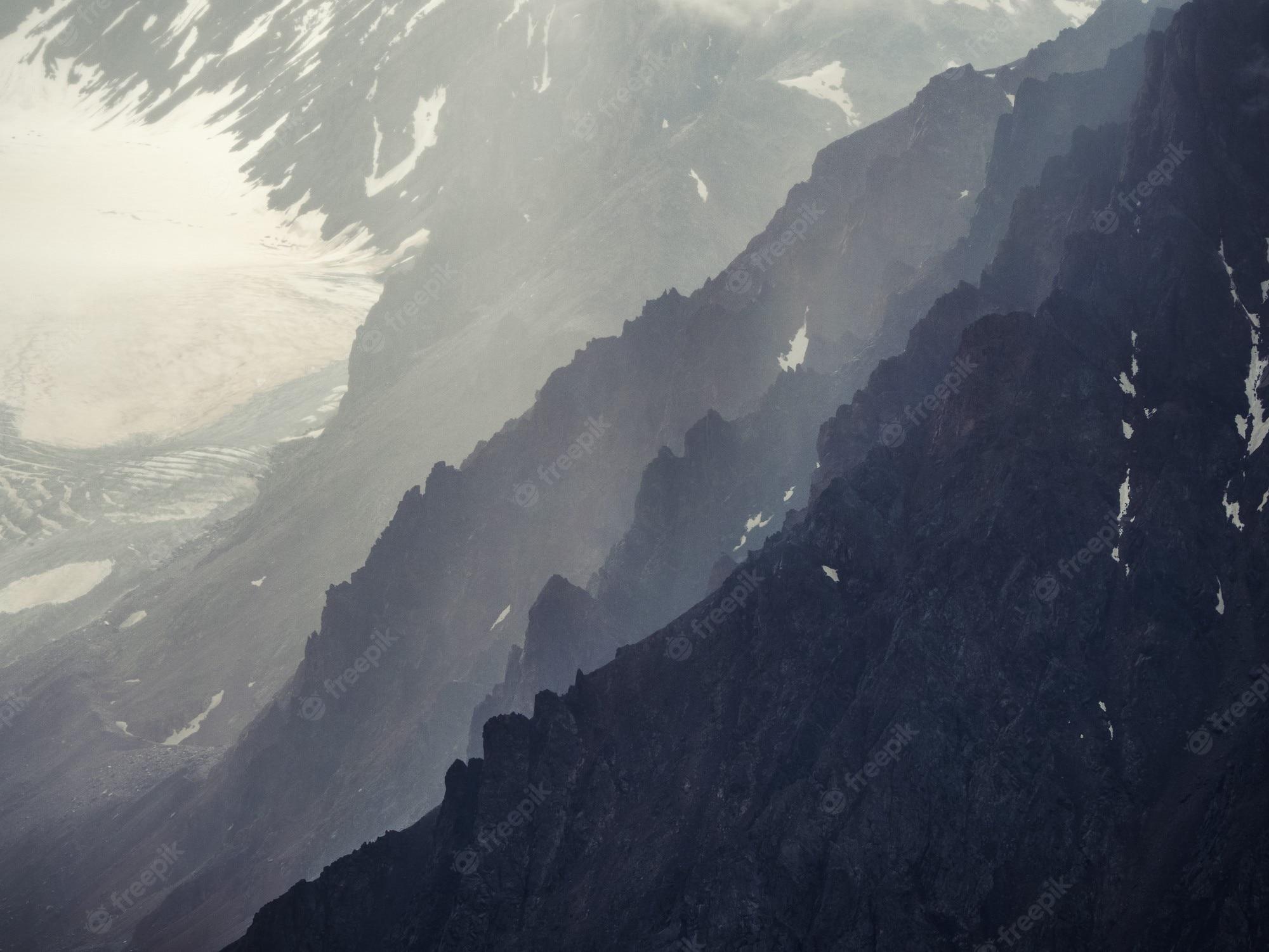 2000x1500 Premium Photo. Soft focus. dramatic sky on mountain peaks. mystical background with dramatic mountains. rain in mountains. rainy mountain natural background