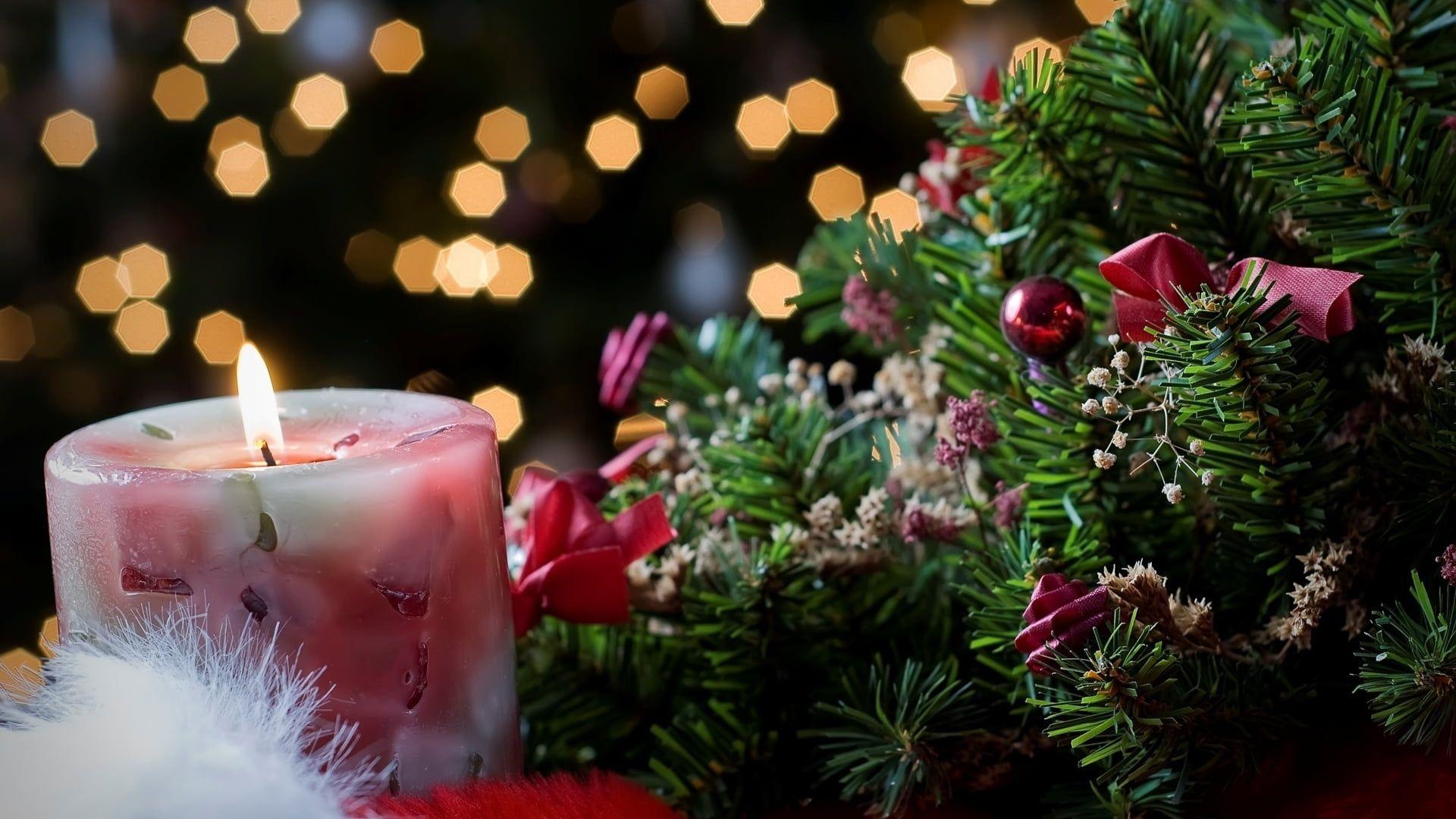 1920x1080 Lighted candle beside Christmas wreath HD wallpaper