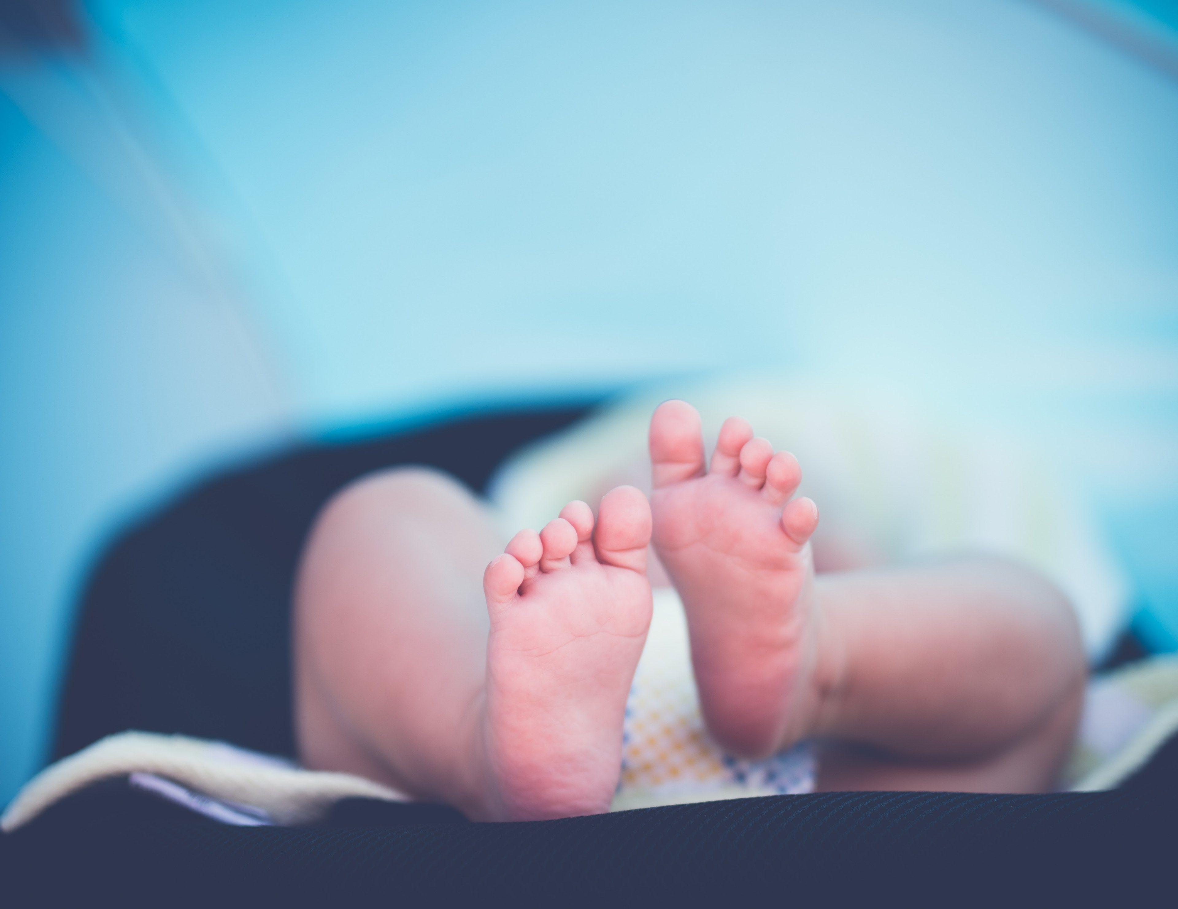 3840x2964 a close up view of a newborn babys feet as the baby lies down