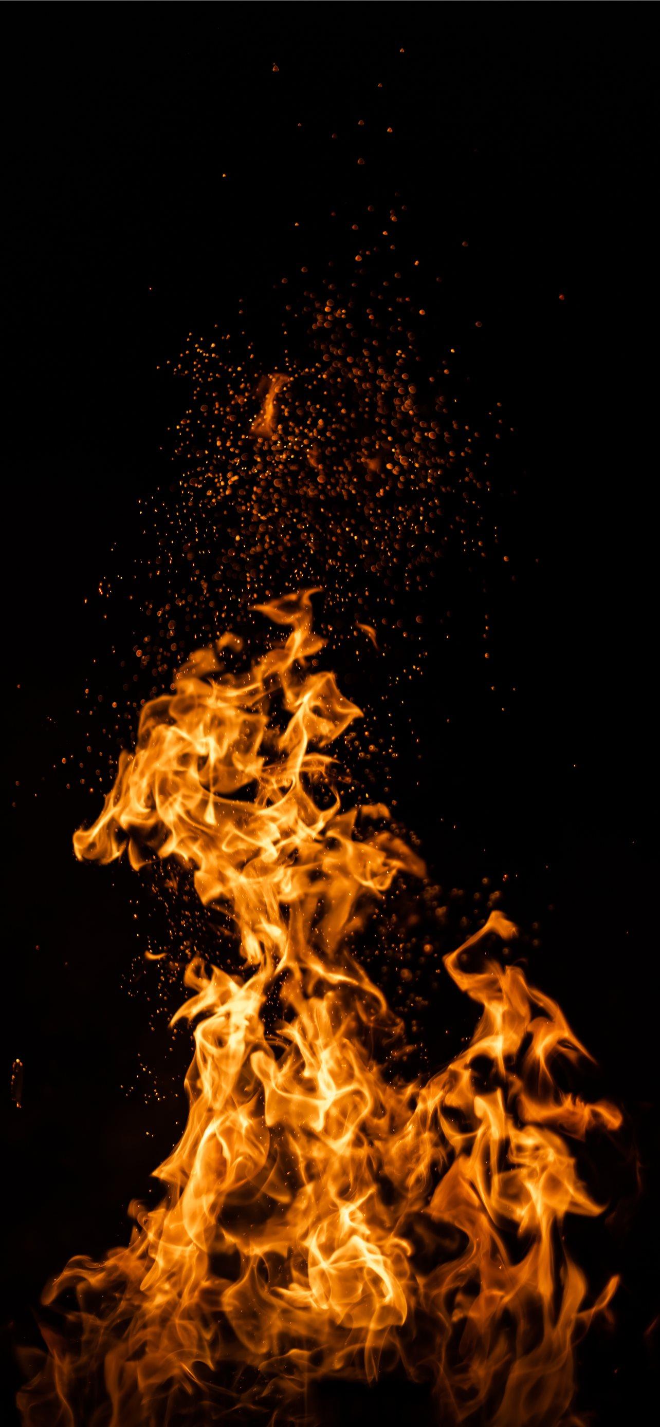 1284x2778 fire in the sky during night time iPhone Wallpaper Free Download