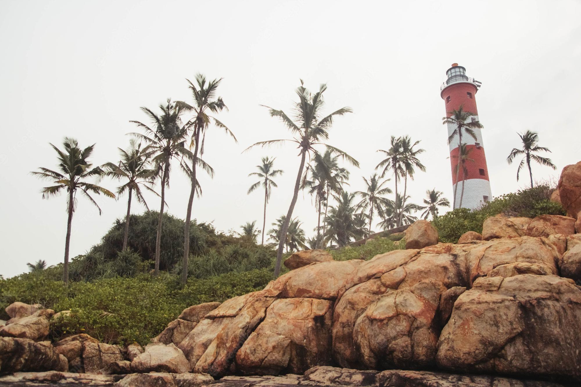 2000x1333 Premium Photo. Lighthouse on the beach at morning dramatic sky in kovalam kerala india