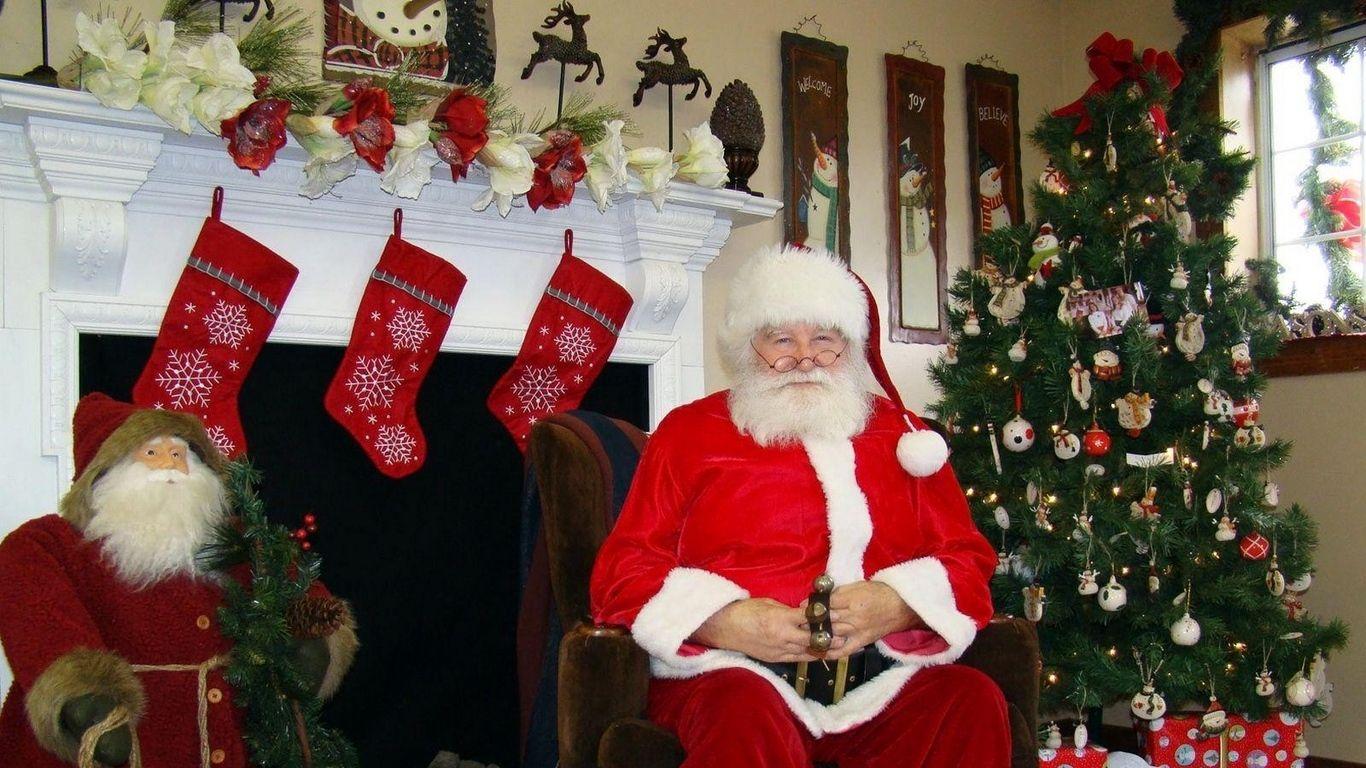 1366x768 Download wallpaper 1366x768 santa claus, christmas, tree, fireplace