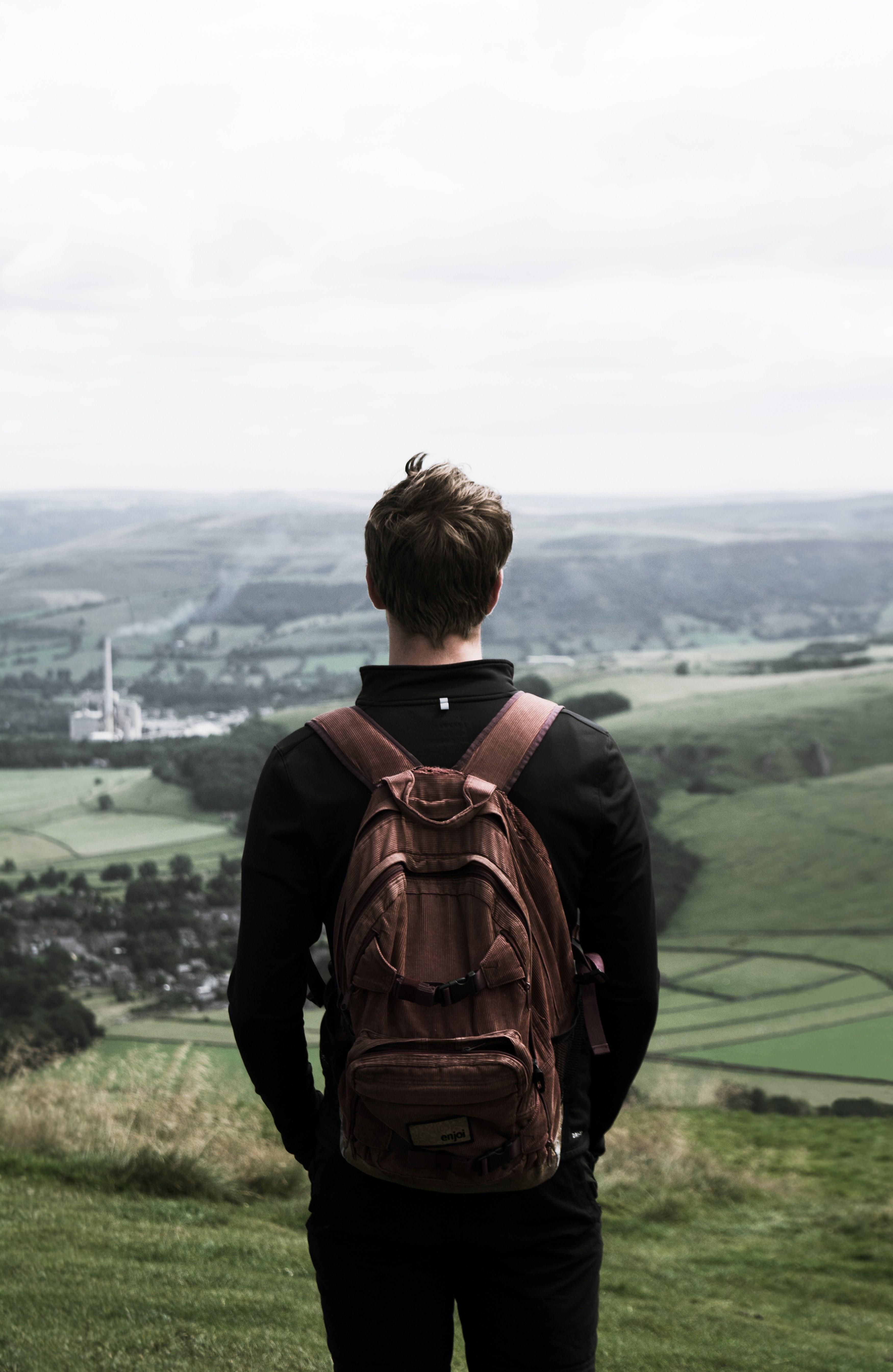 3501x5378 solo traveller stands in a backpack