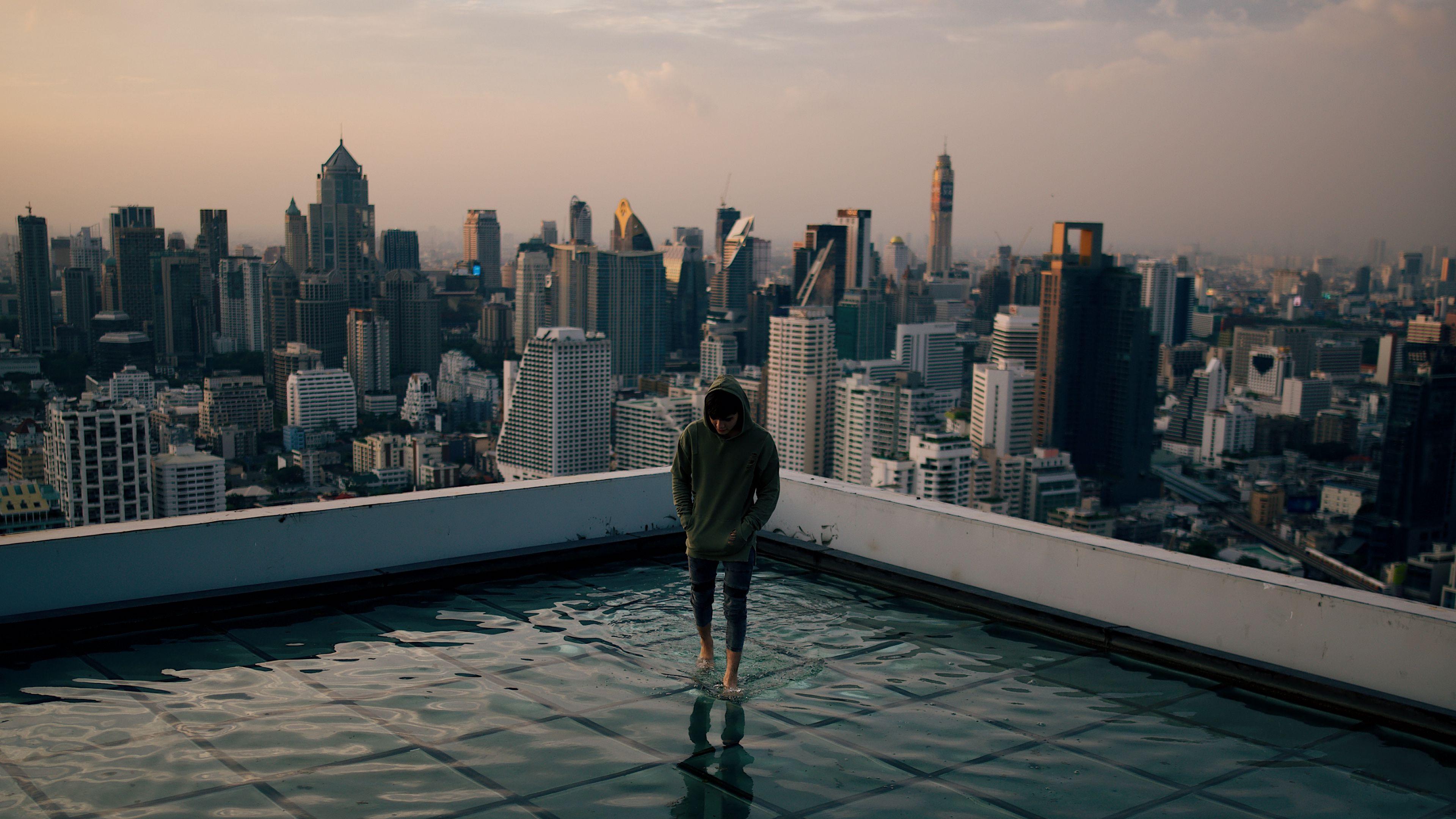 3840x2160 Wallpaper / man, roof, water, city, horizon, wet, after rain, 4k free download