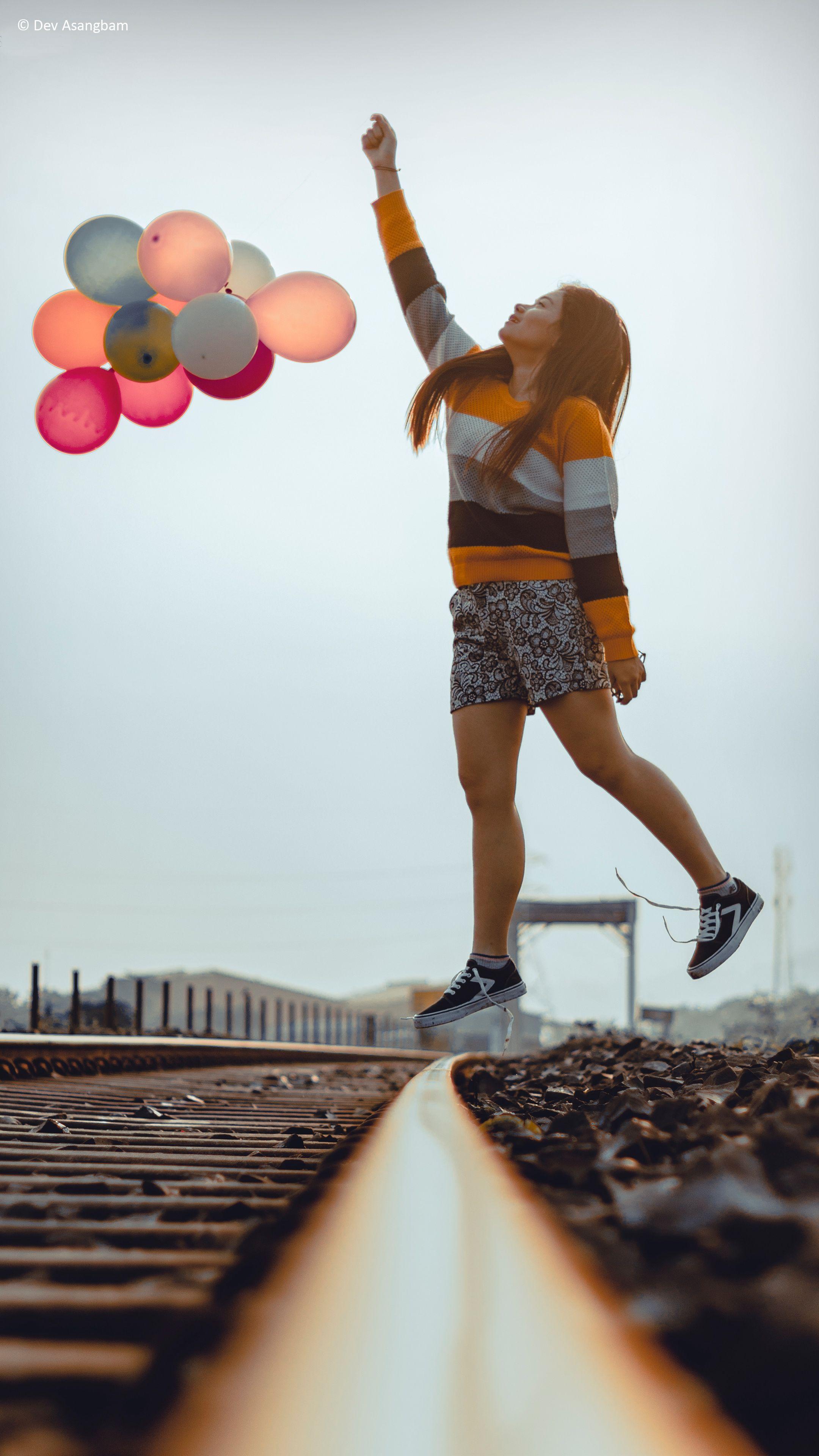 2160x3840 Download Happy Girl Jumping Balloons Train Track Photography Free