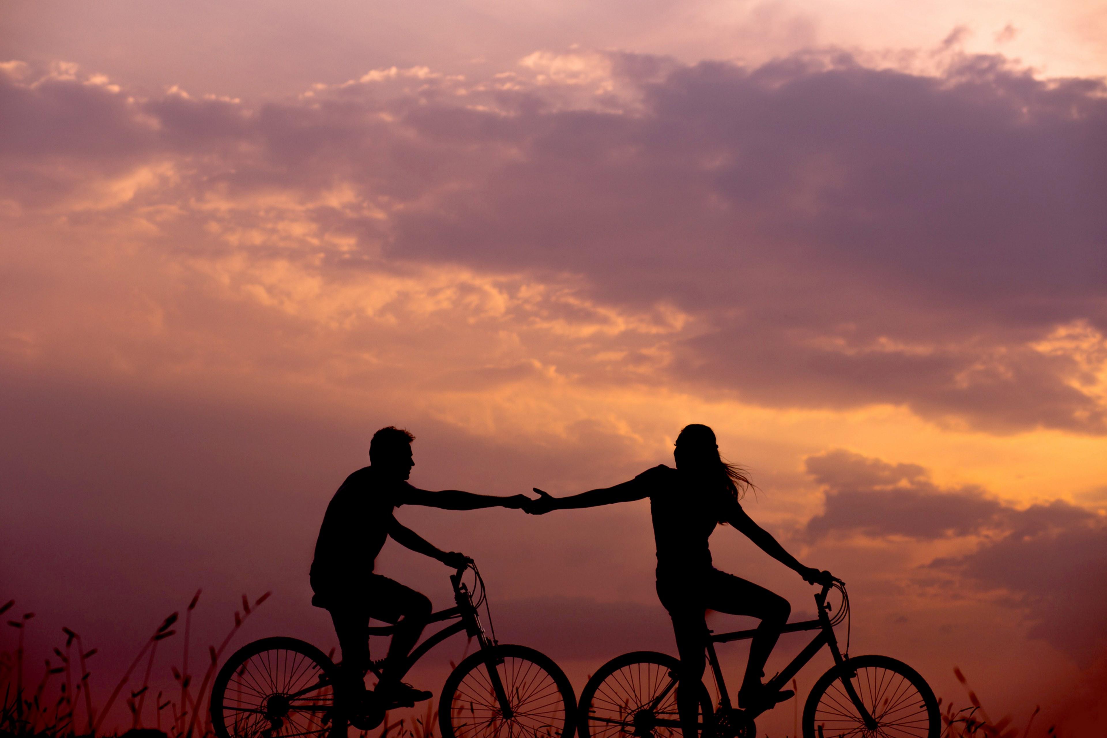 3840x2560 Wallpaper / lovers share a silhouetted bicycle ride hands reaching out to each other, dont let go 4k wallpaper free download