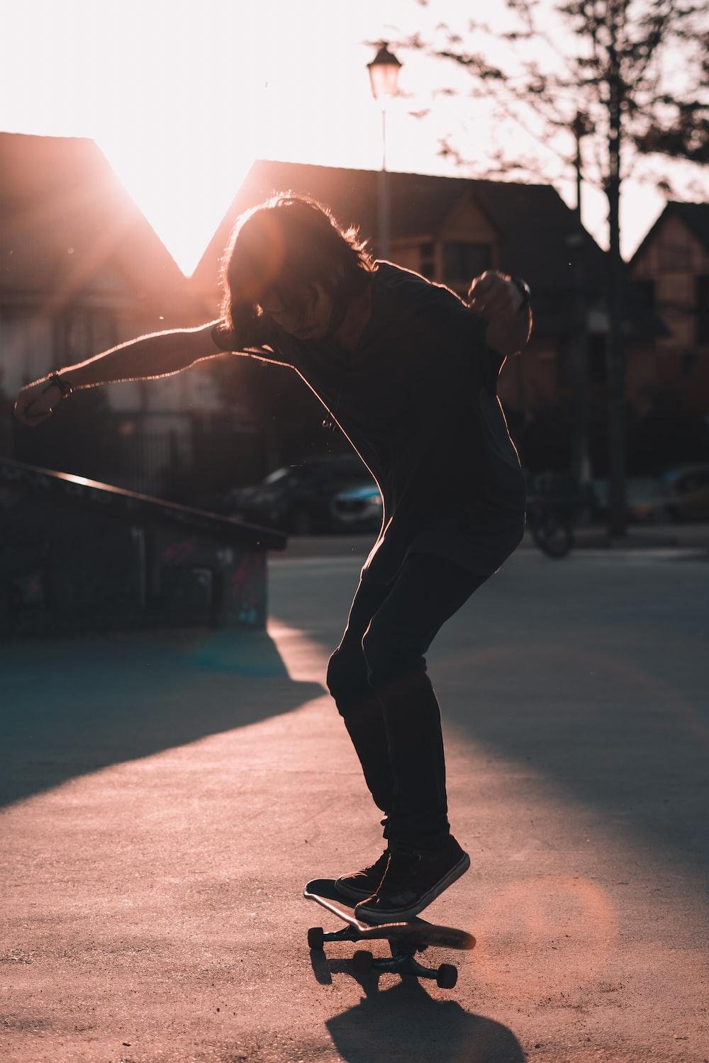 1000x1500 man skateboarding on pavement photo