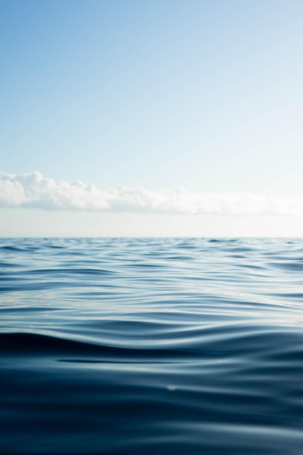 1000x1500 blue ocean water under blue sky during daytime photo