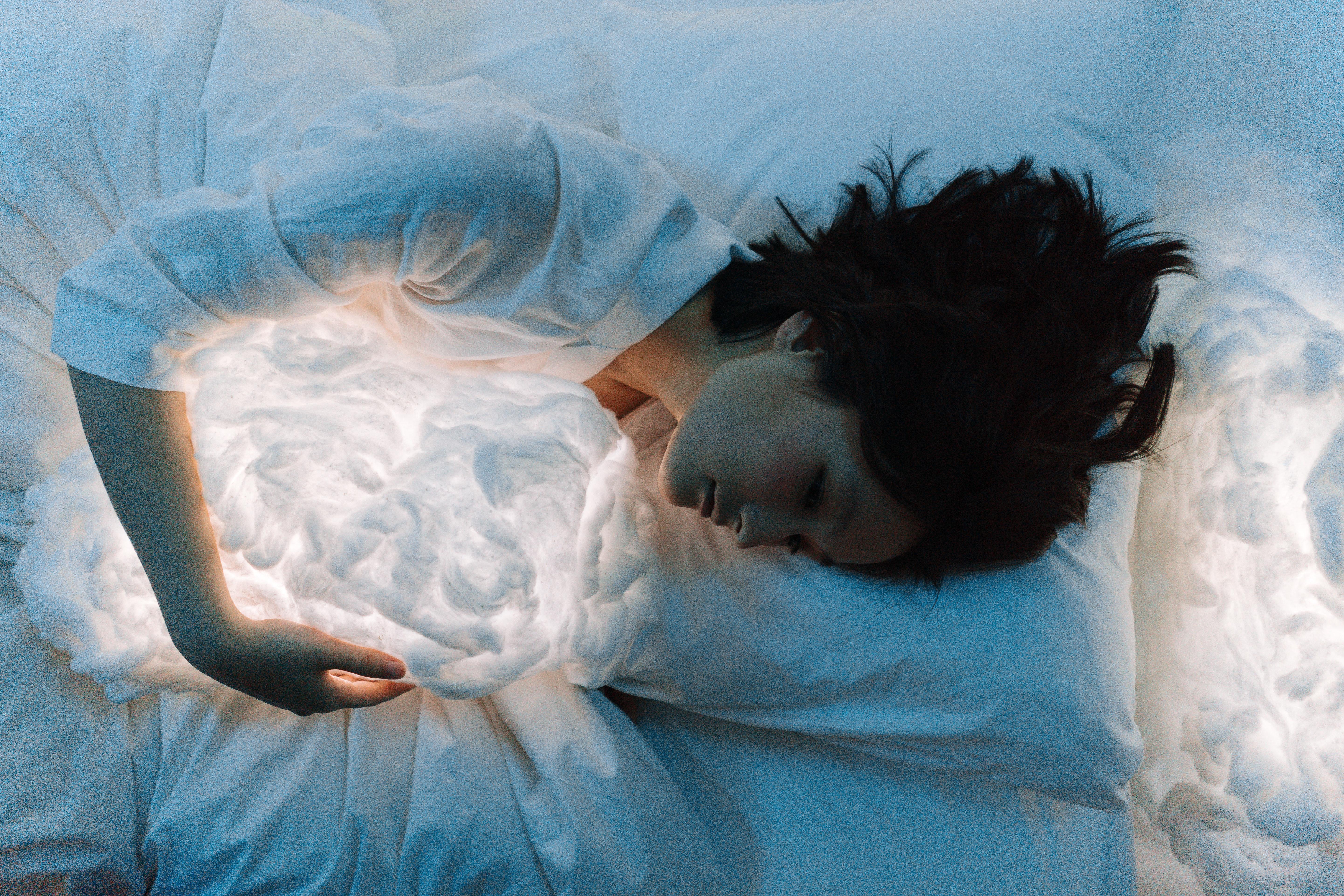 5767x3845 A Person Hugging a Cloud Pillow while Lying on the Bed · Free
