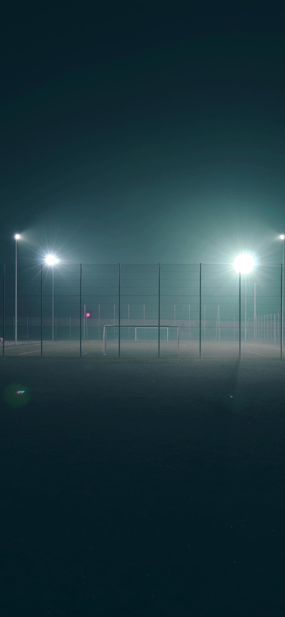 1125x2436 iPhone X wallpaper. soccer field city night light dark green