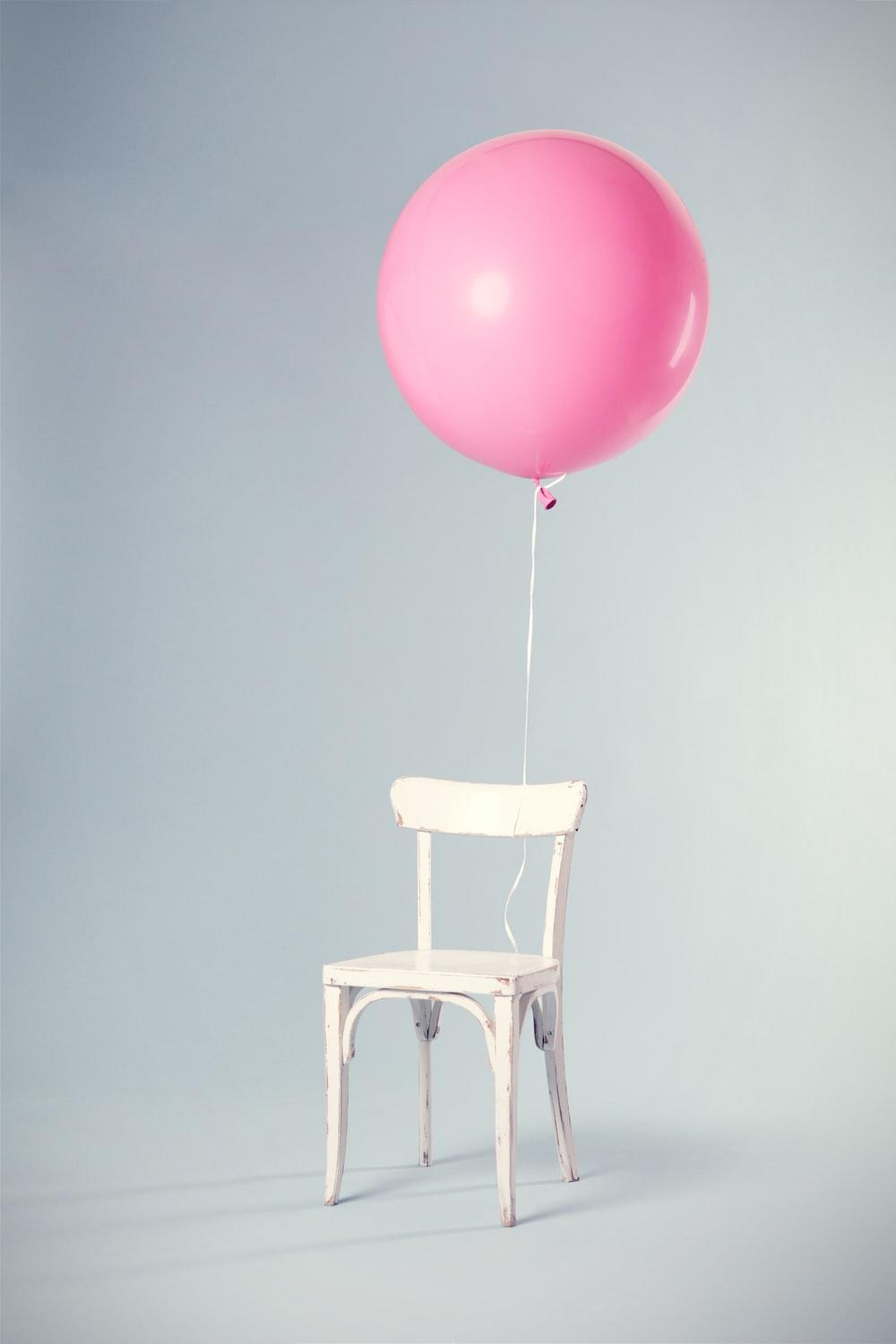 1000x1500 pink balloon tied on white wooden chair photo