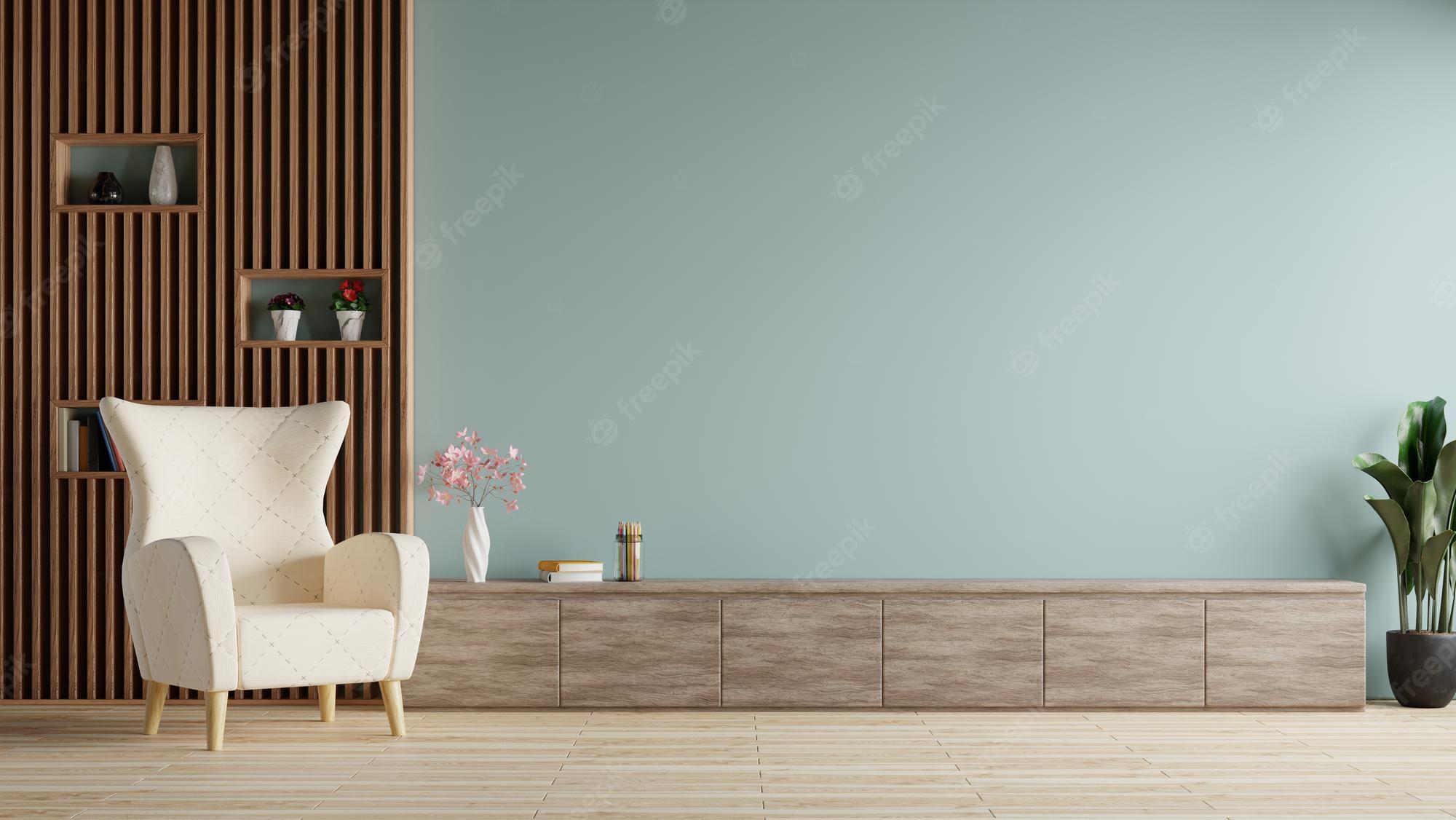 2000x1126 Premium Photo. Modern living room with white armchairs on the floor, flowers and notebooks on the tv table. blue wall as background.3D rendering