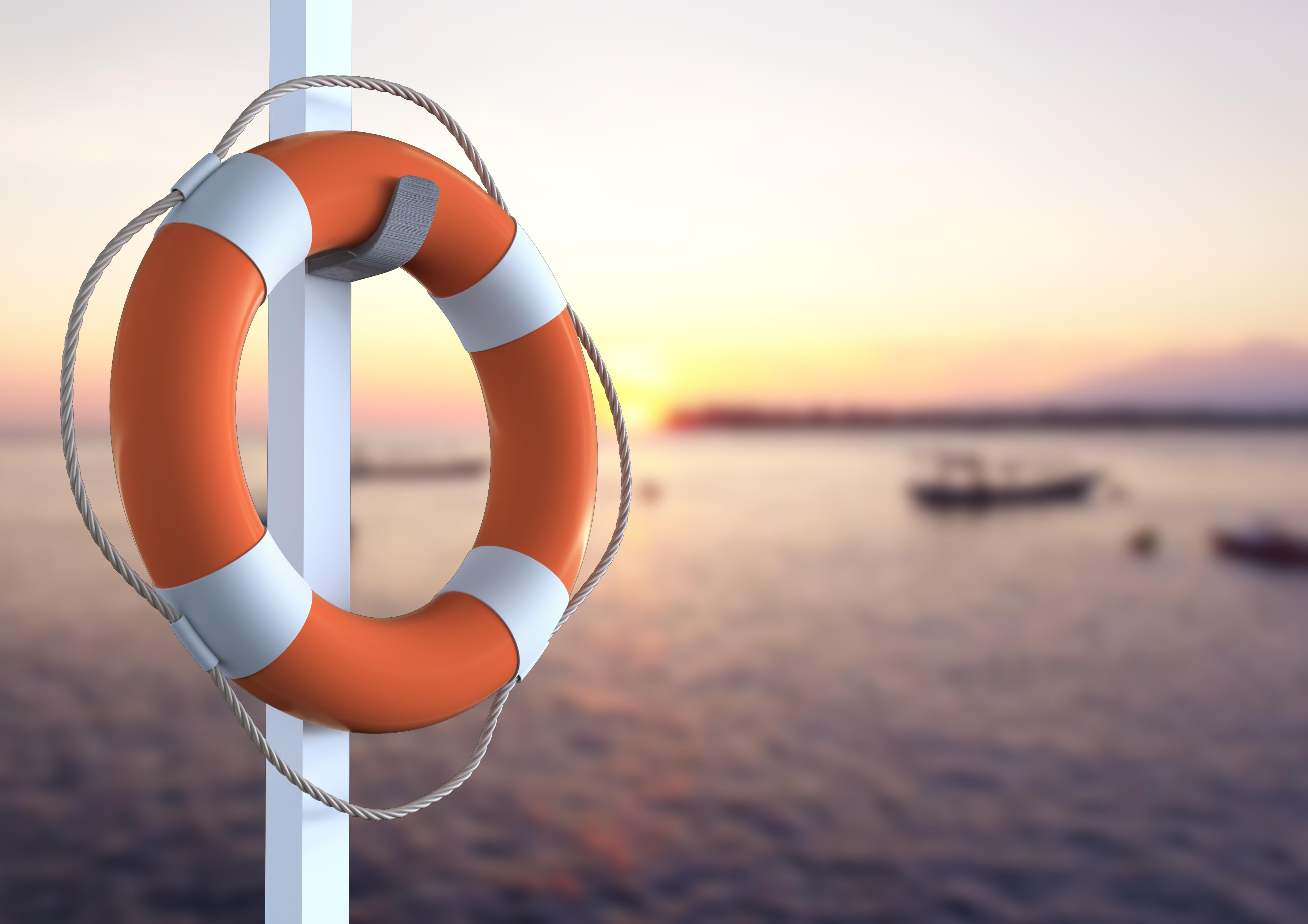 5600x3959 Lifebuoy hanging on pole against waterfront in background Photo from PikWizard